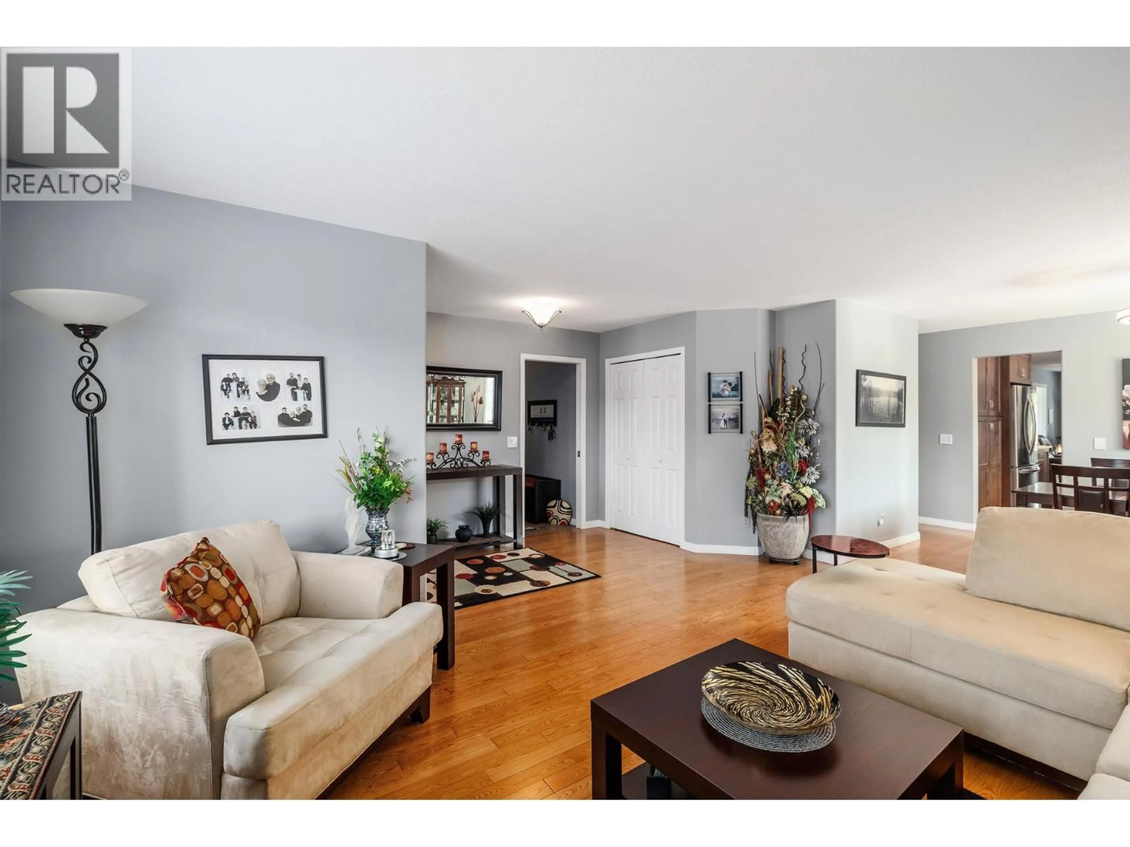 Living room with furniture, wood/laminate floor for 64 - 615 GLENMEADOWS ROAD, Kelowna British Columbia V1V1N9