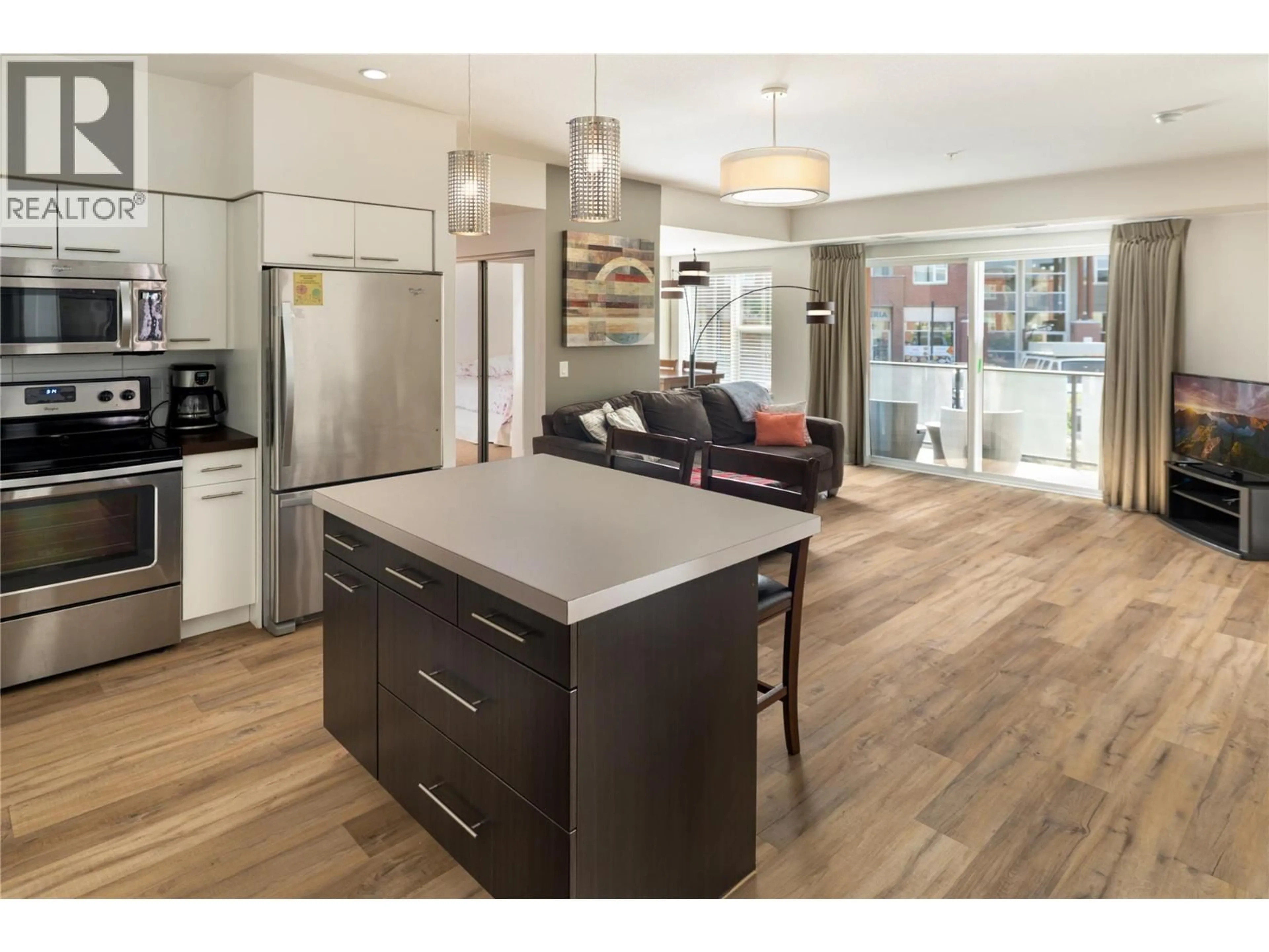 Open concept kitchen, wood/laminate floor for 208 - 985 ACADEMY WAY, Kelowna British Columbia V1V3C8
