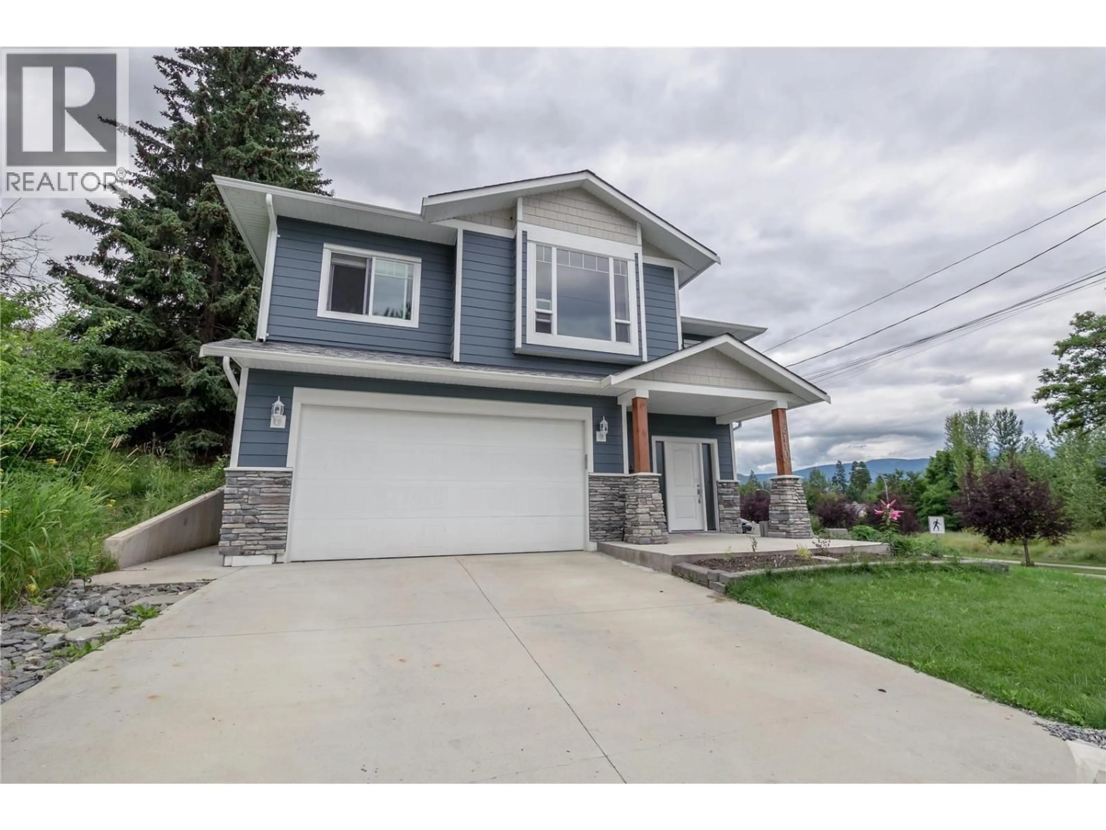 Home with vinyl exterior material, street for 2110 6 AVENUE NORTHEAST, Salmon Arm British Columbia V1E2K8