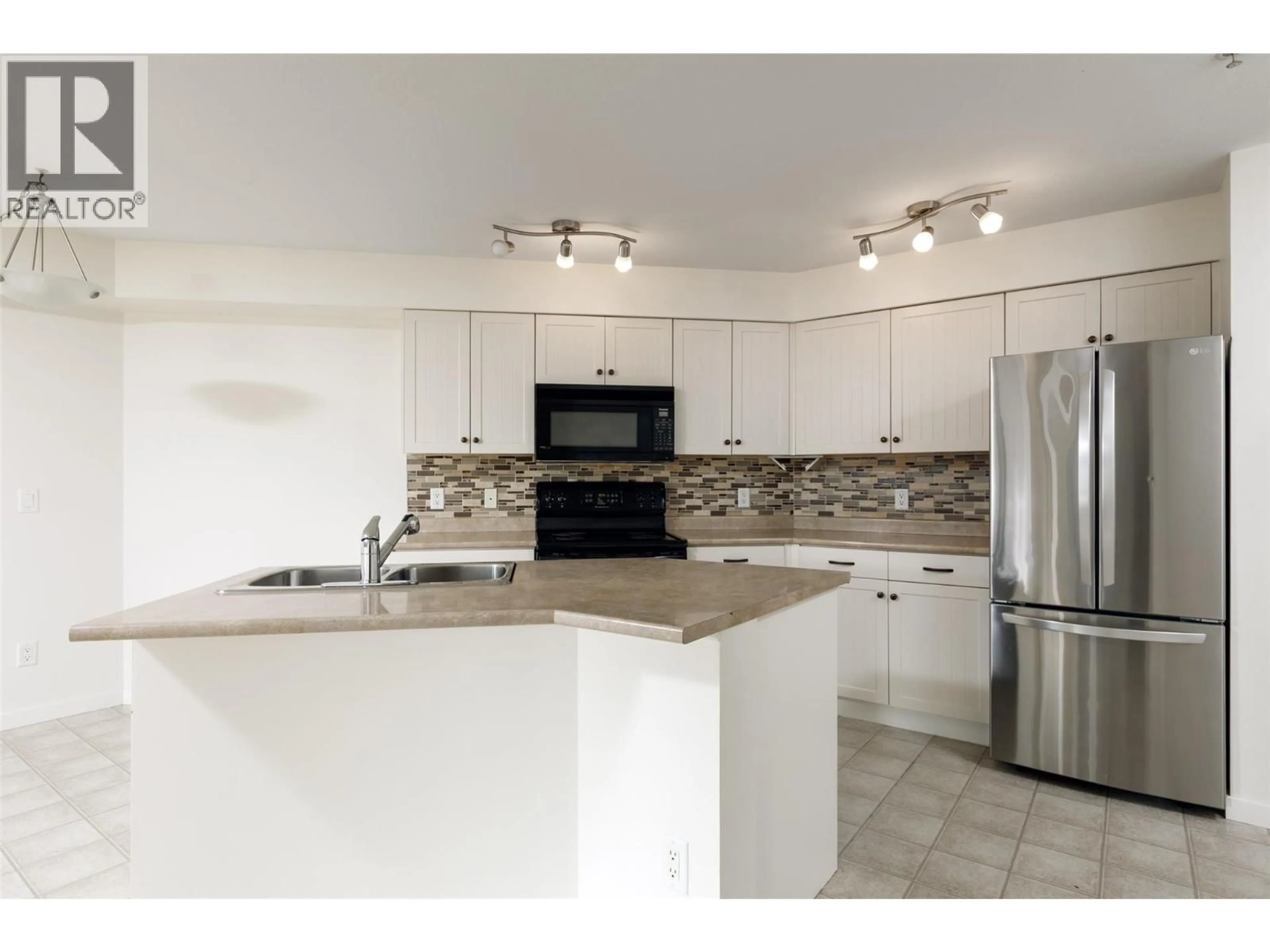 Open concept kitchen, ceramic/tile floor for 111 - 135 ZIPRICK ROAD, Kelowna British Columbia V1X8B2