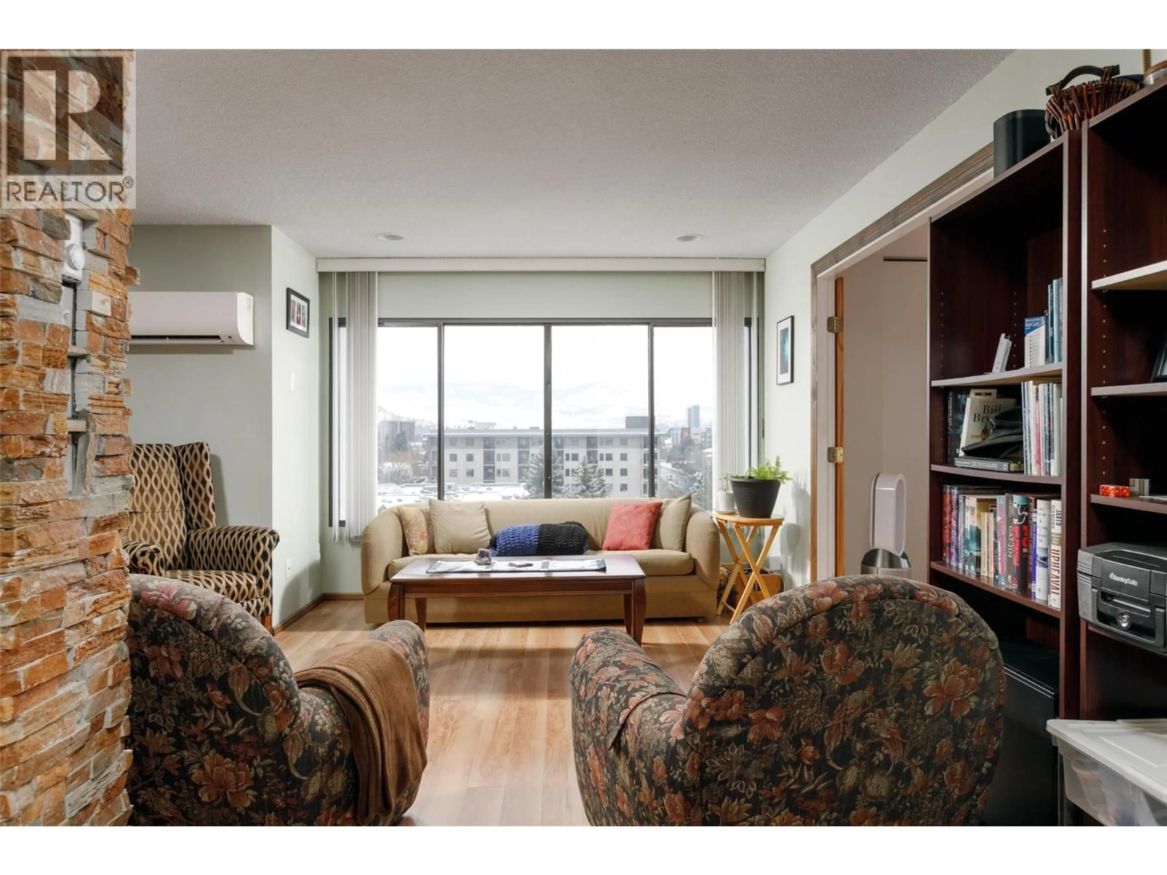 Living room with furniture, wood/laminate floor for 807 - 737 LEON AVENUE, Kelowna British Columbia V1Y8L6
