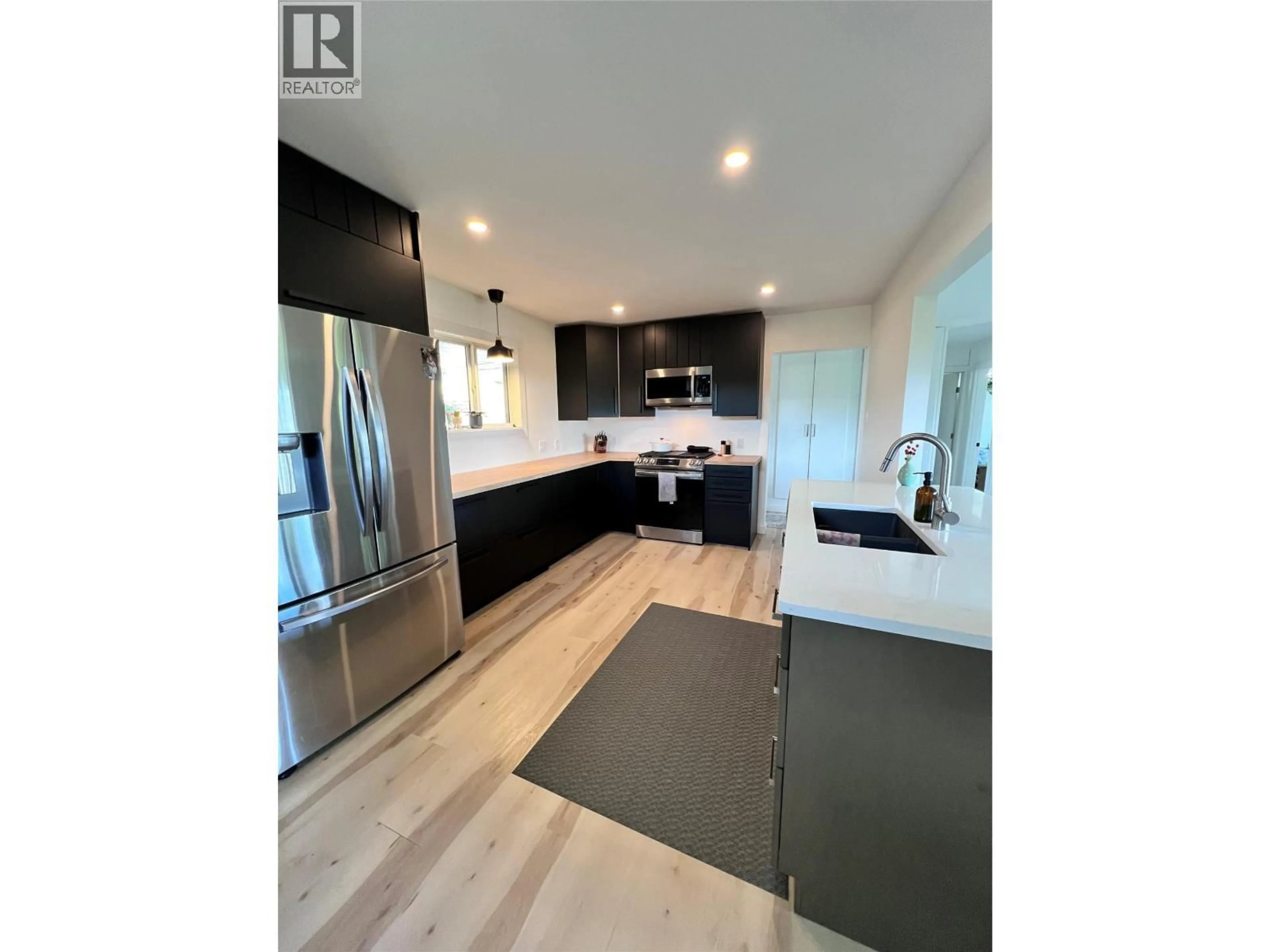Open concept kitchen, wood/laminate floor for 2077 DERRY LANE, Lumby British Columbia V0E2G0
