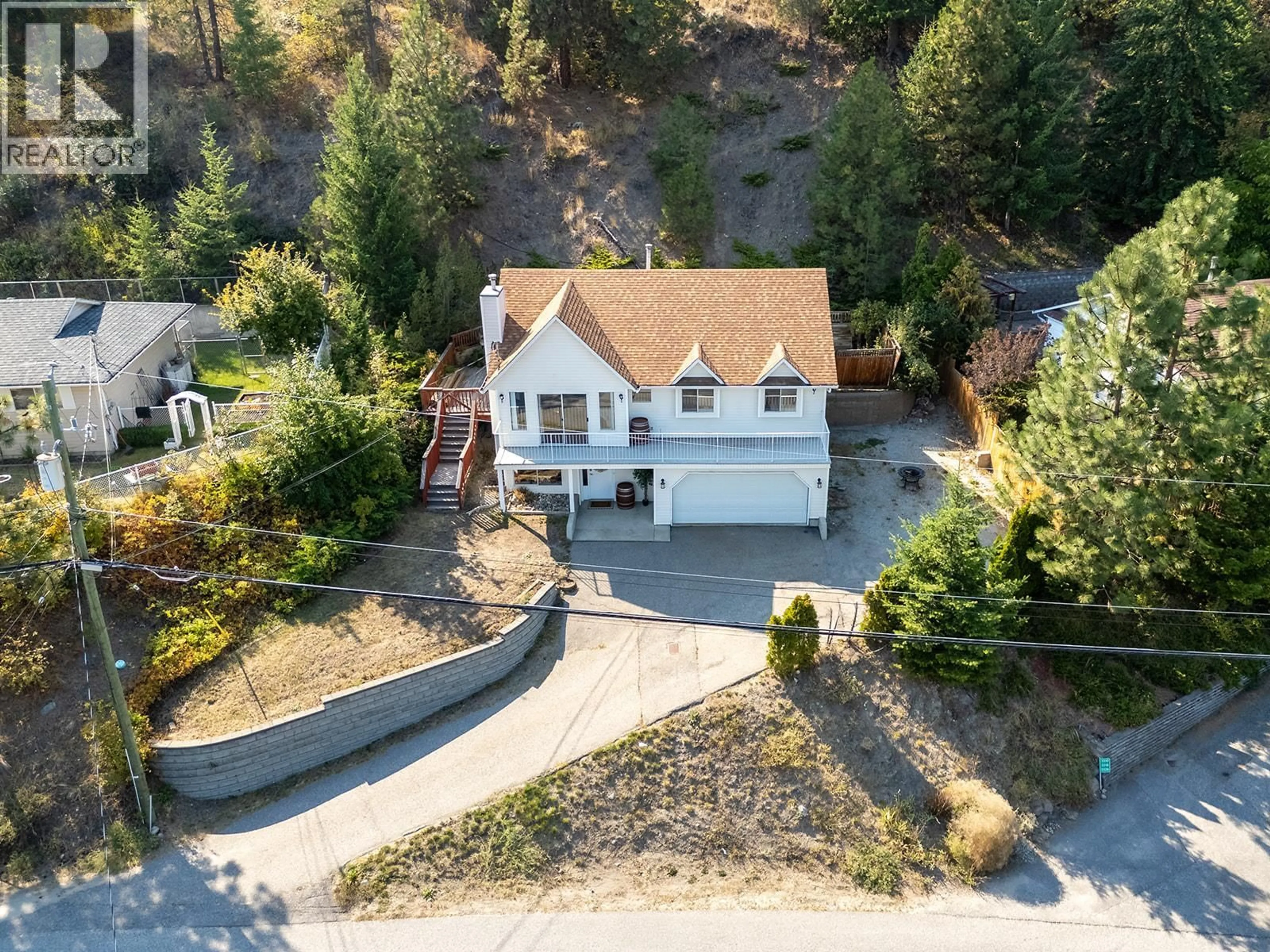 A pic from outside/outdoor area/front of a property/back of a property/a pic from drone, street for 3334 MCQUEEN ROAD, West Kelowna British Columbia V4T1B7