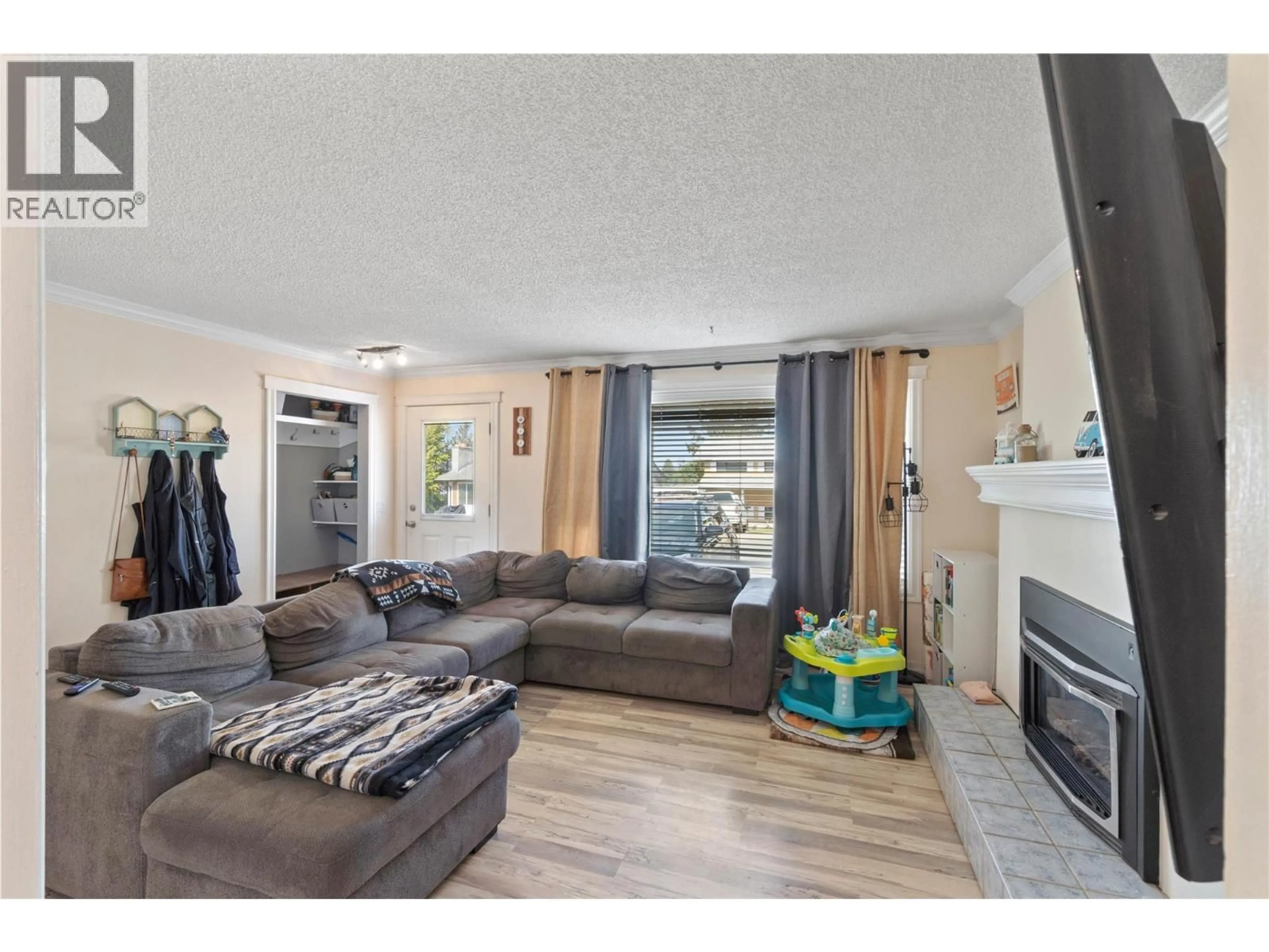 Living room with furniture, wood/laminate floor for 254 ALDER DRIVE, Logan Lake British Columbia V0K1W0