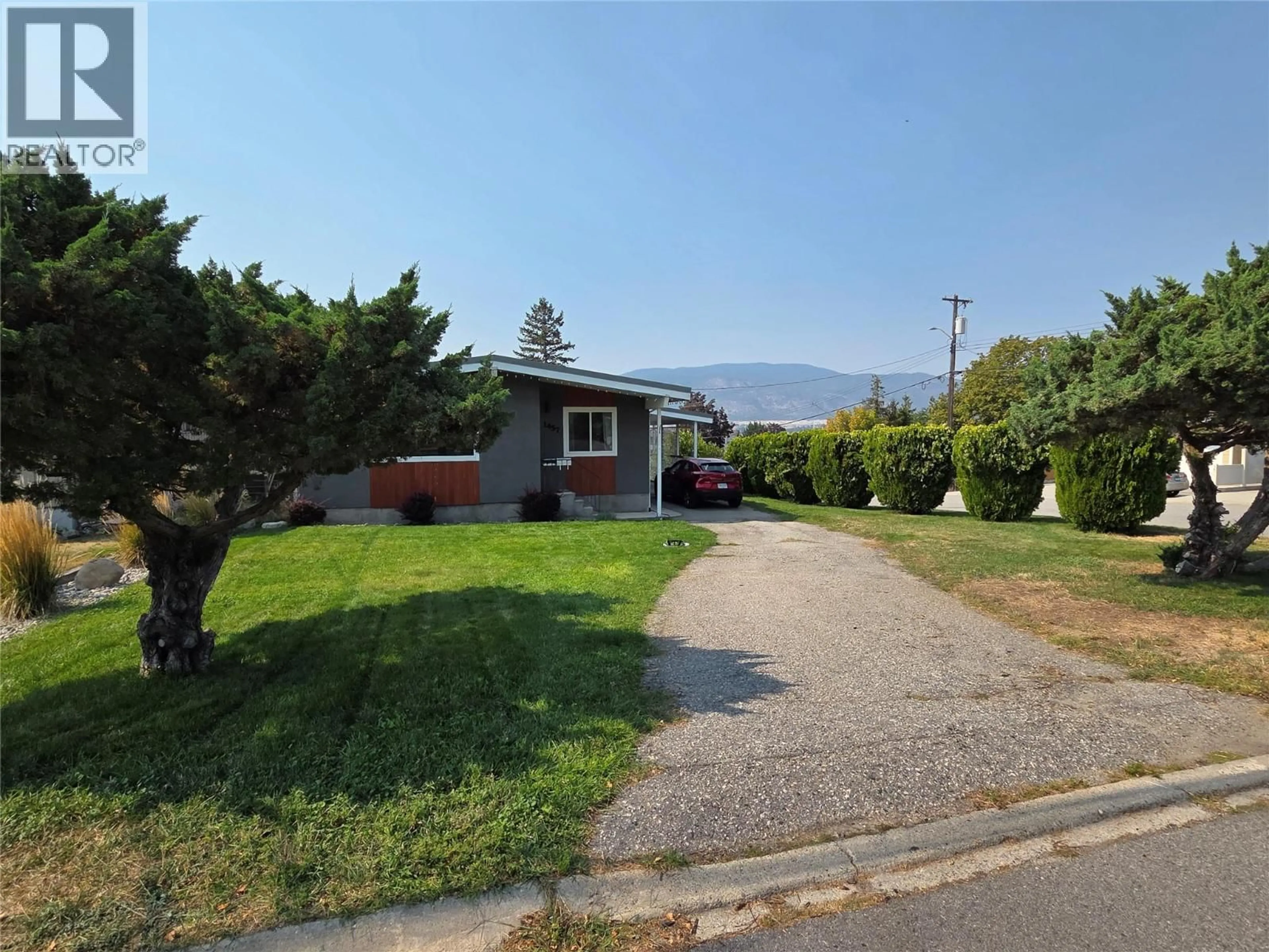 A pic from outside/outdoor area/front of a property/back of a property/a pic from drone, mountain view for 1457 CARMI DRIVE, Penticton British Columbia V2A4R9