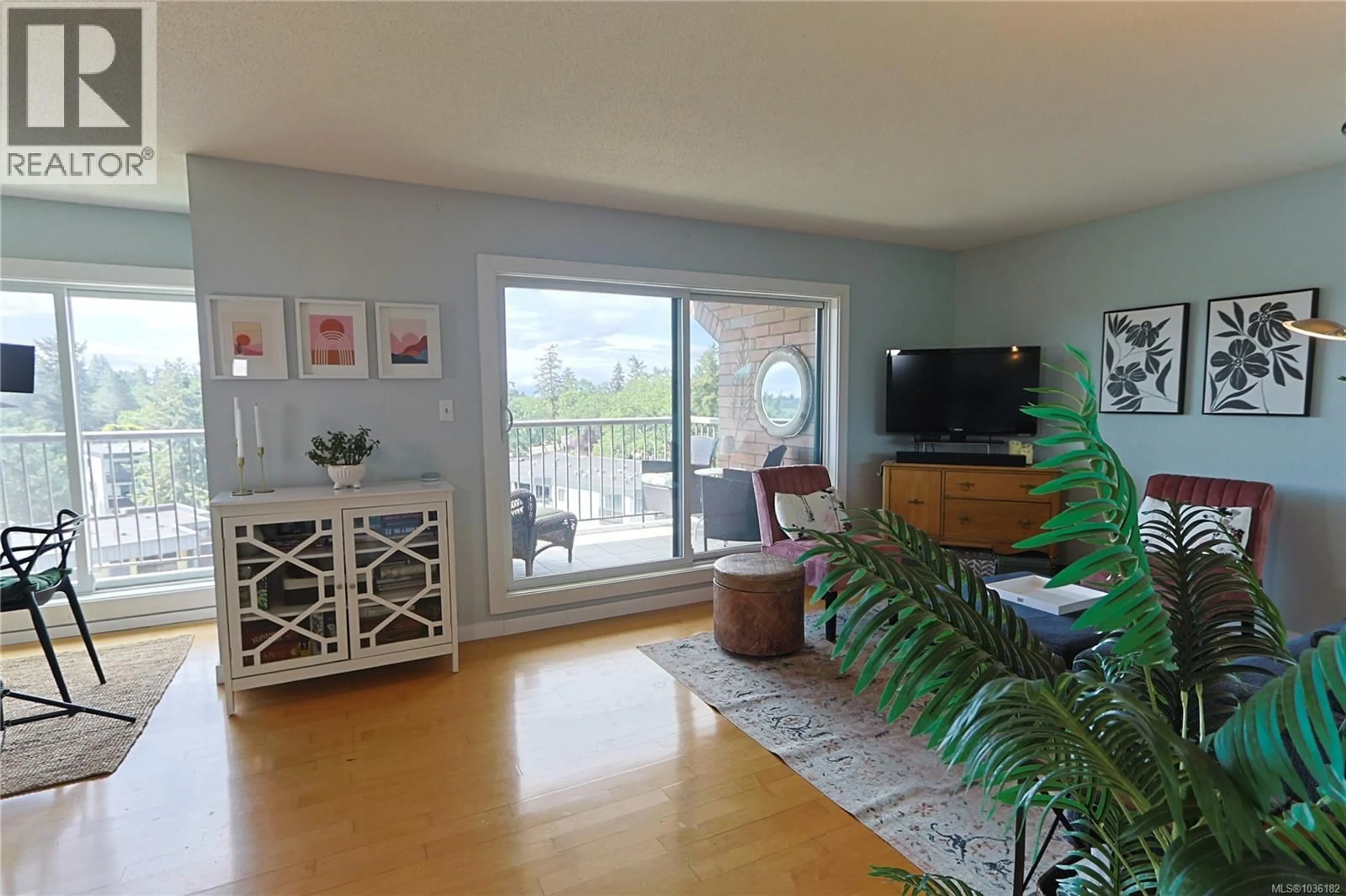 Living room with furniture, wood/laminate floor for 604 - 4030 QUADRA STREET, Saanich British Columbia V8X1K2