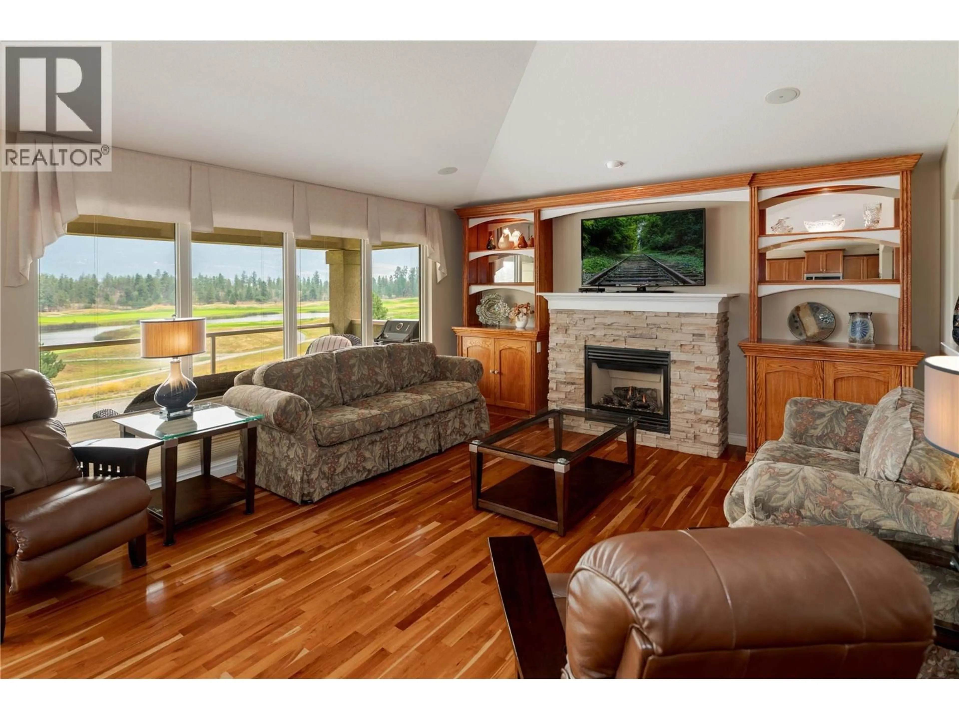 Living room with furniture, wood/laminate floor for 111 - 2455 QUAIL RIDGE BOULEVARD, Kelowna British Columbia V1V2S8