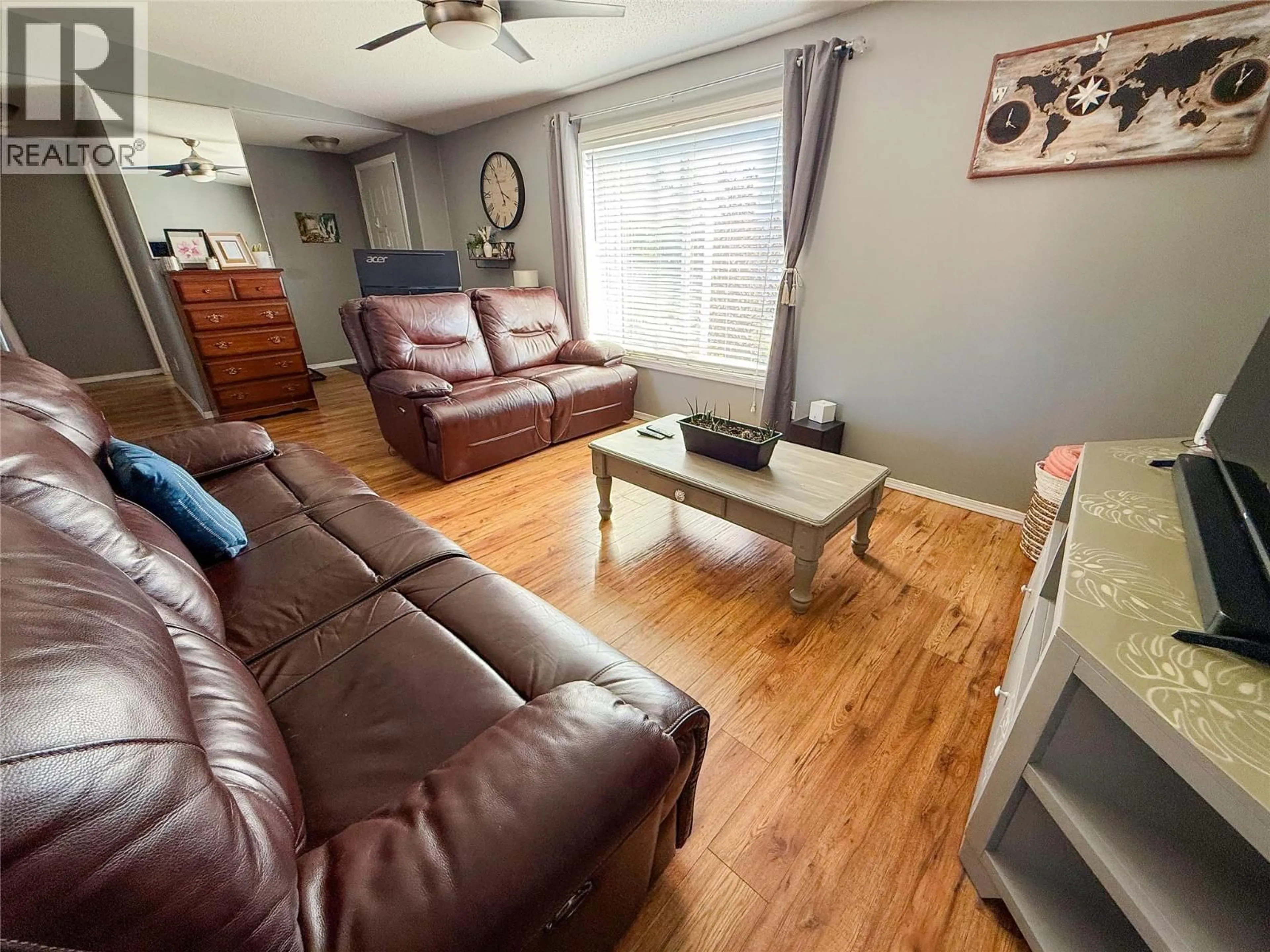 Living room with furniture, wood/laminate floor for 5418 49 STREET, Pouce Coupe British Columbia V0C2C0
