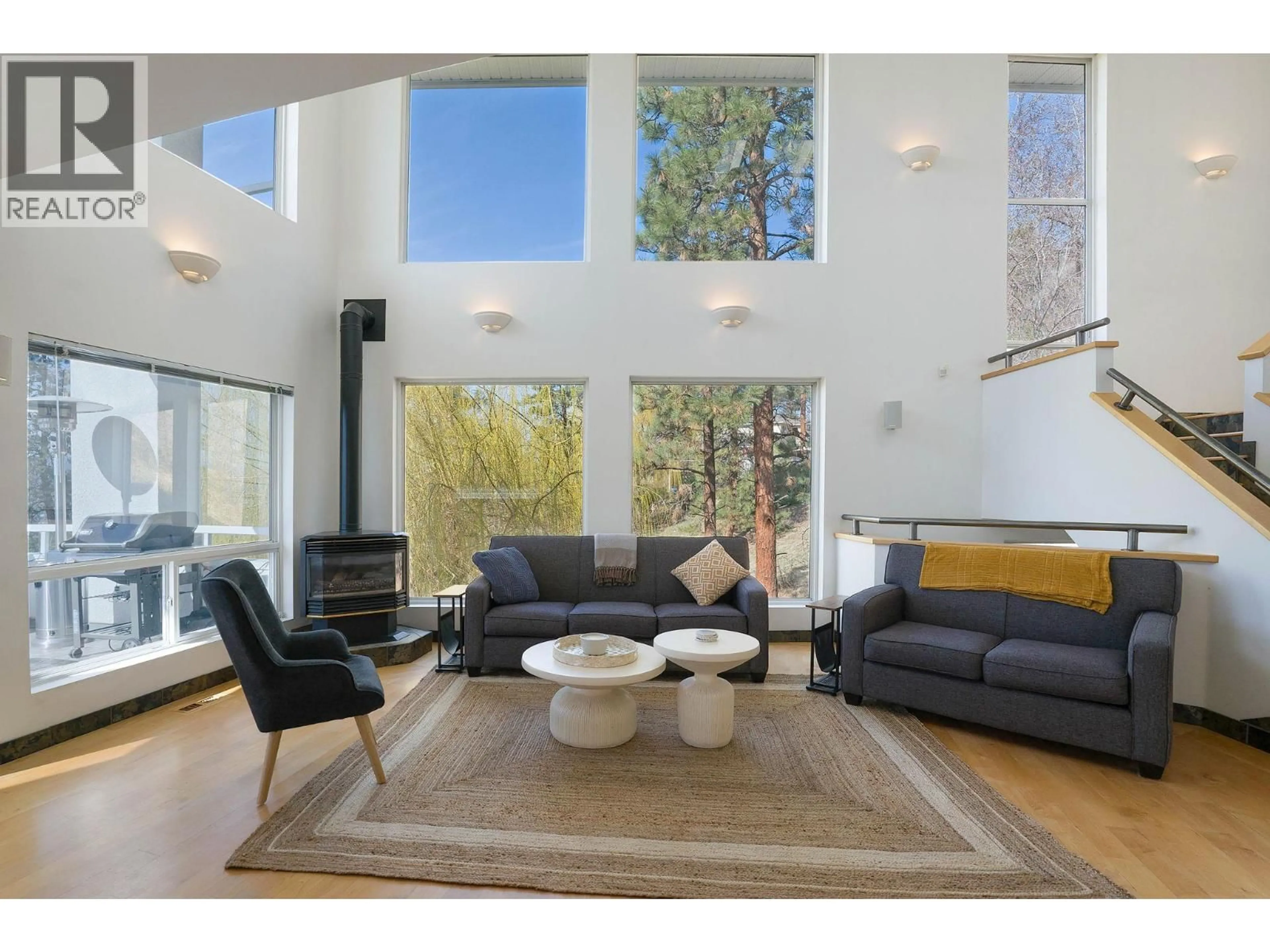 Living room with furniture, wood/laminate floor for 1022 JAMES HOCKEY PLACE, Kelowna British Columbia V1X7L2