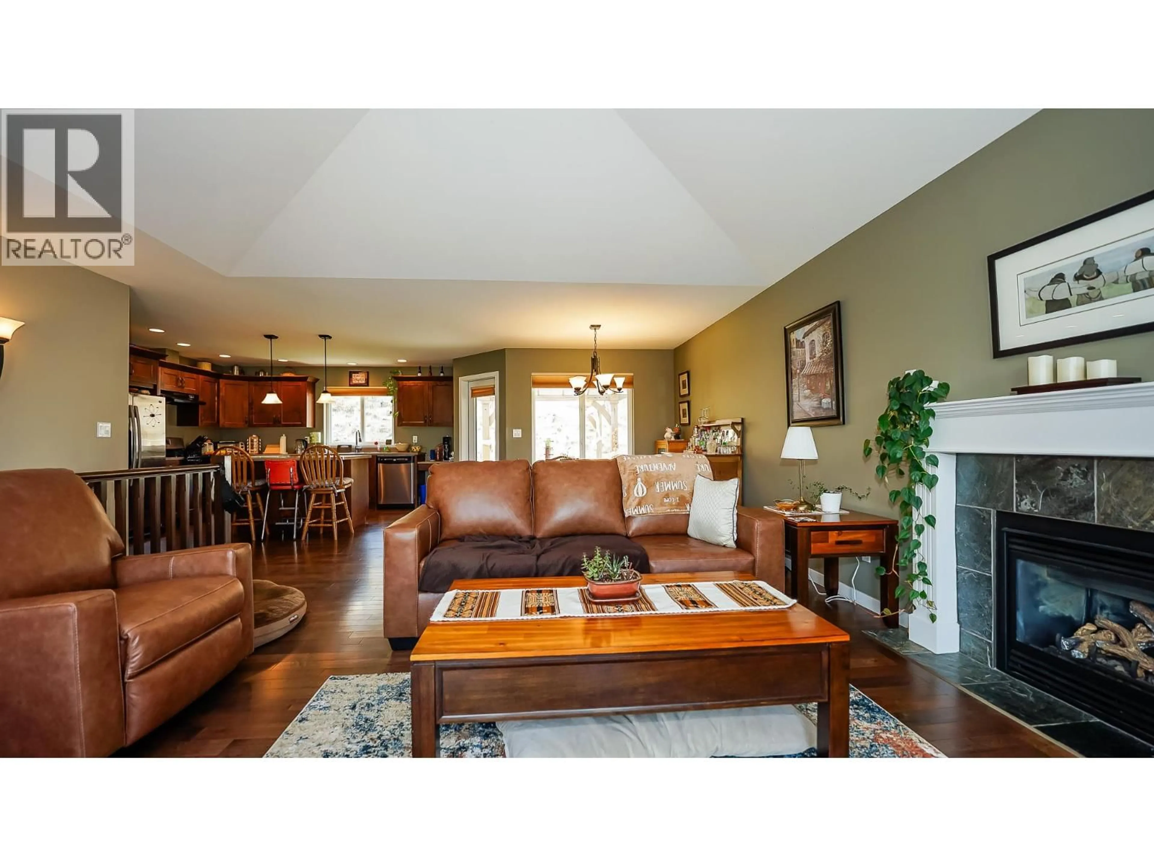 Living room with furniture, wood/laminate floor for 2023 SADDLEBACK DRIVE, Kamloops British Columbia V2B0A6