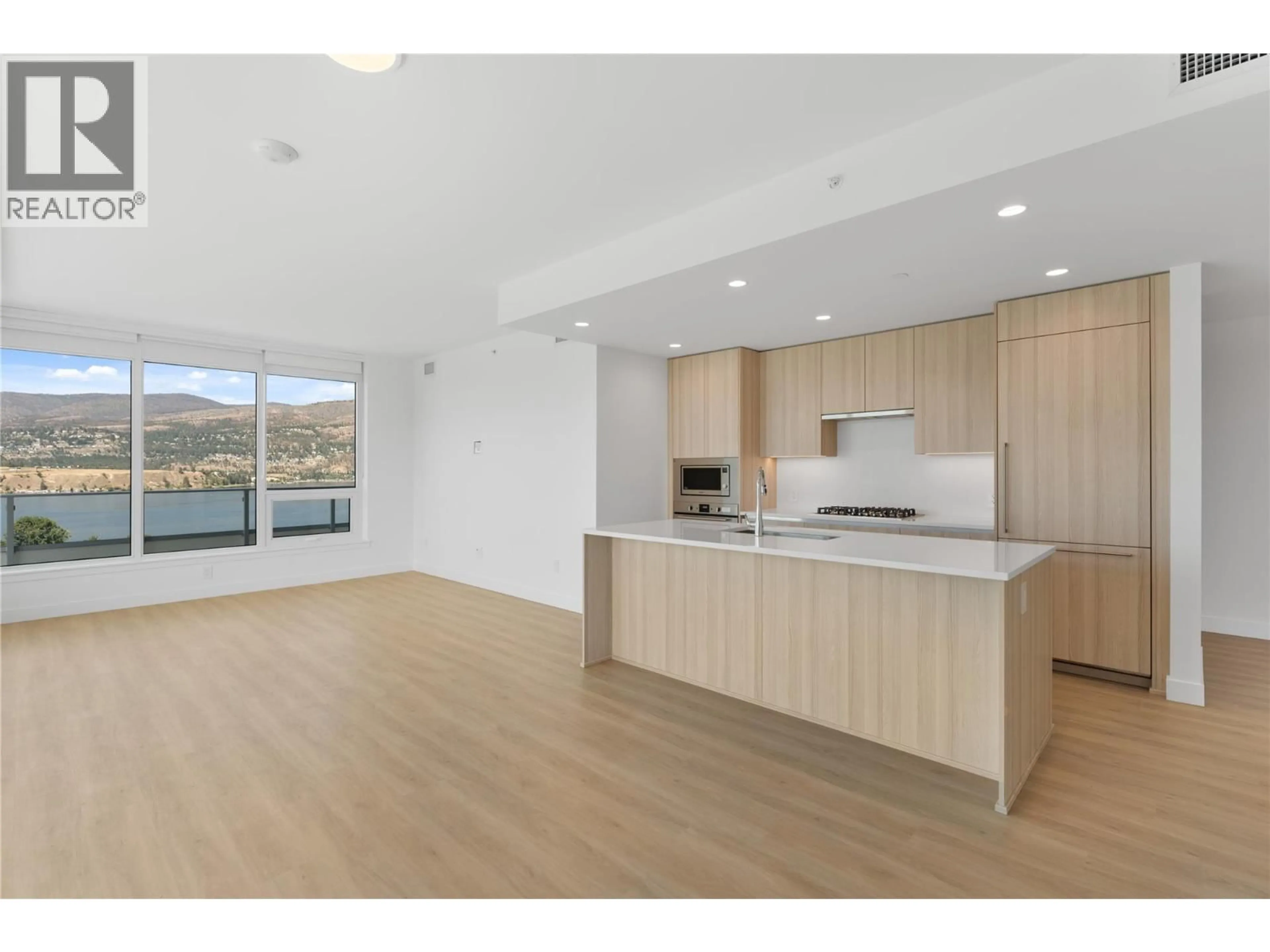 Open concept kitchen, wood/laminate floor for 1407 - 238 LEON AVENUE, Kelowna British Columbia V1Y0N6