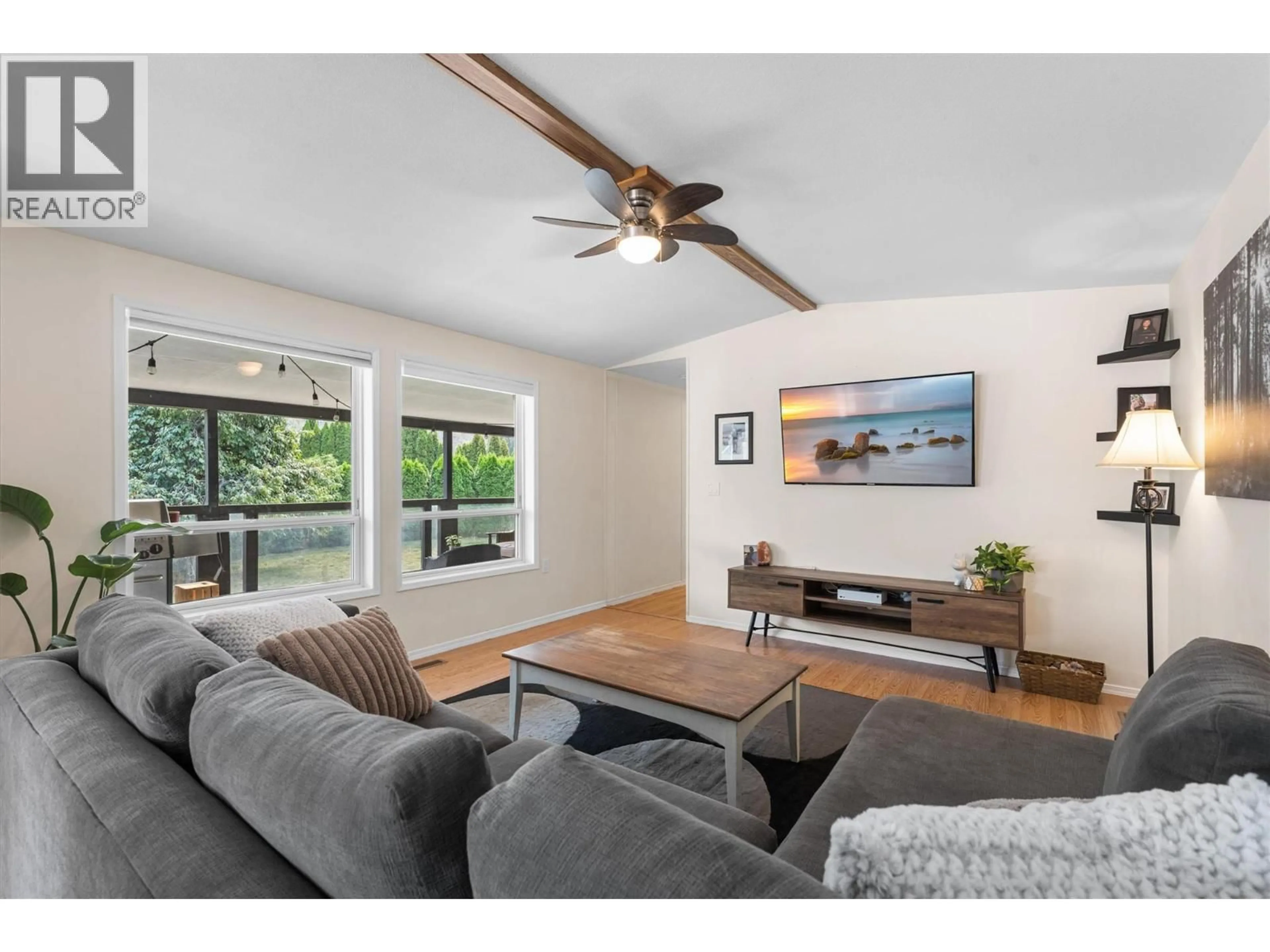 Living room with furniture, wood/laminate floor for 101 - 1699 ROSS ROAD, West Kelowna British Columbia V1Z1L8