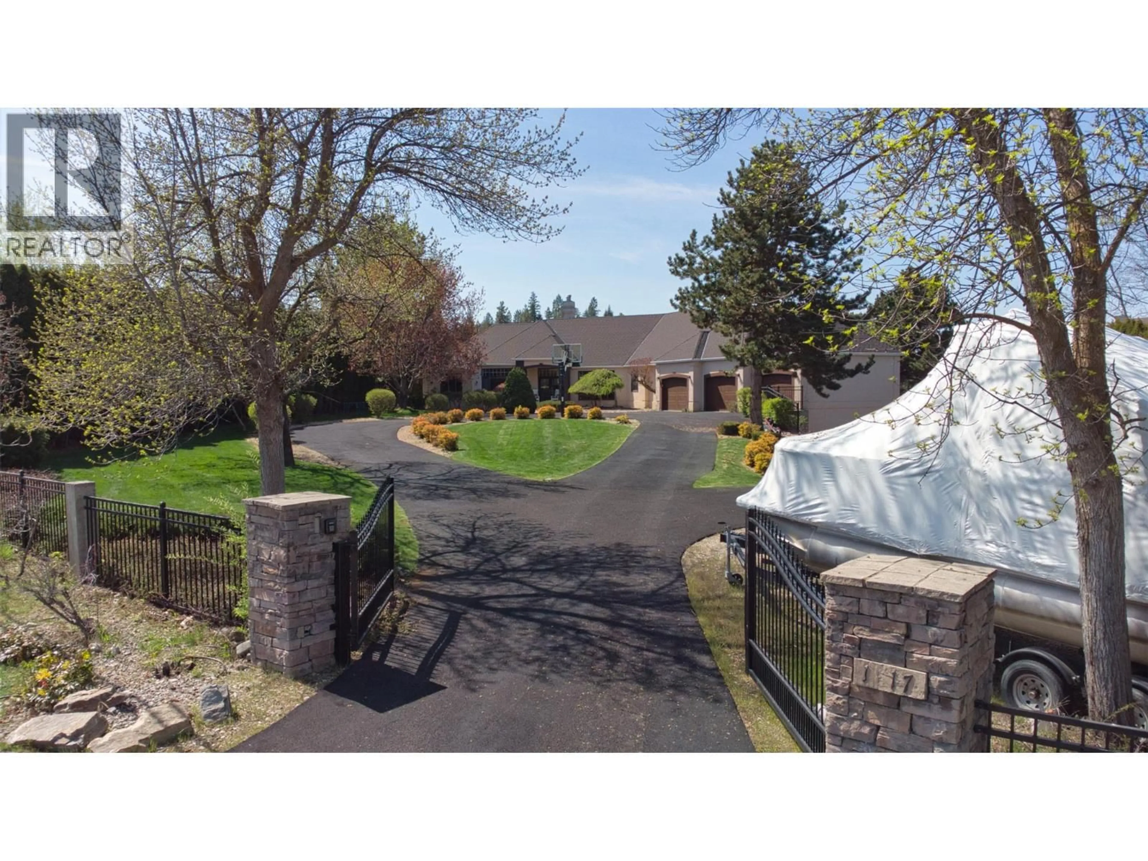 A pic from outside/outdoor area/front of a property/back of a property/a pic from drone, street for 1117 CRAWFORD ROAD, Kelowna British Columbia V1Z3L7