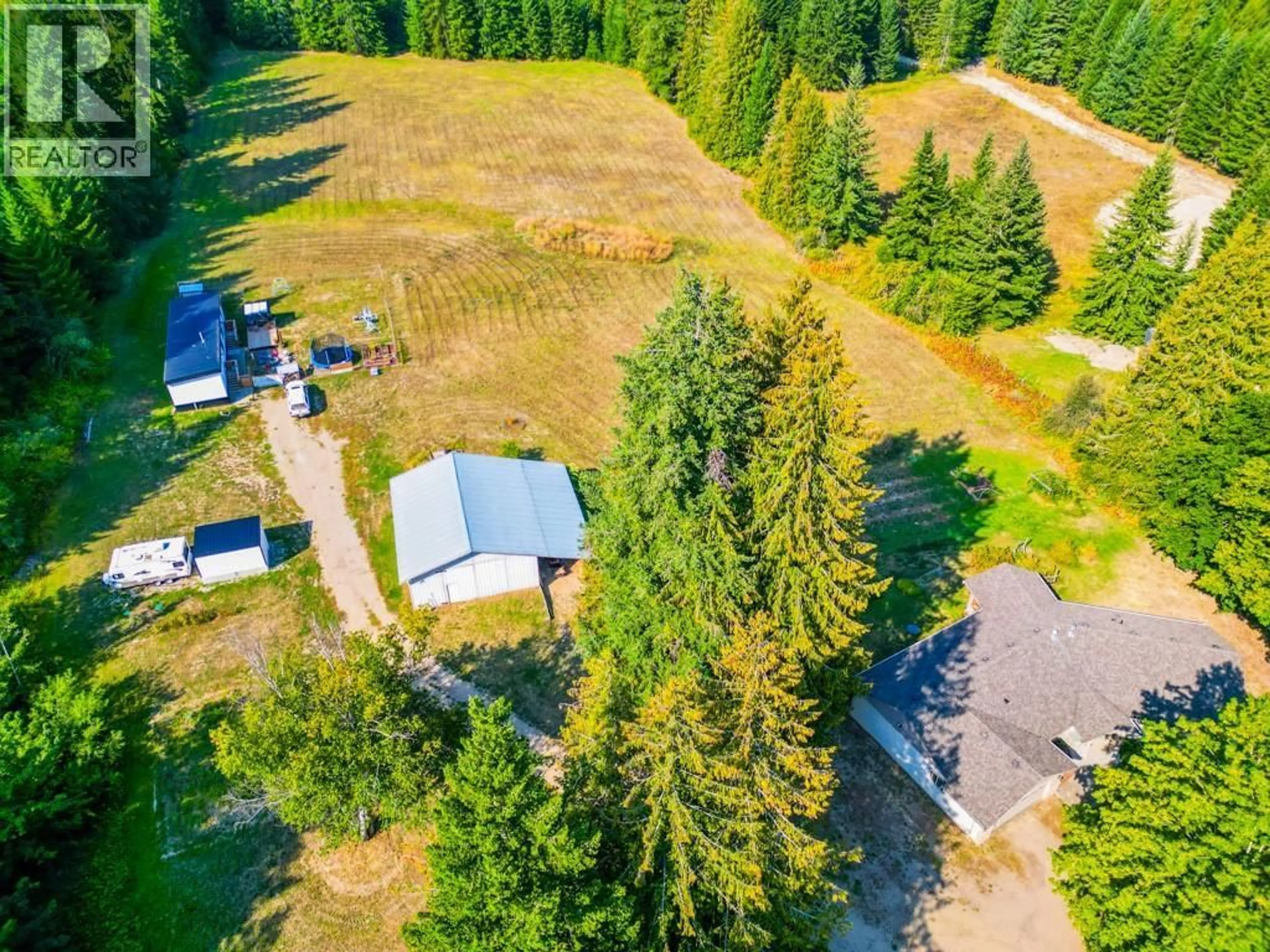 A pic from outside/outdoor area/front of a property/back of a property/a pic from drone, forest/trees view for 4571 50 STREET NORTHEAST, Salmon Arm British Columbia V1E1Y6
