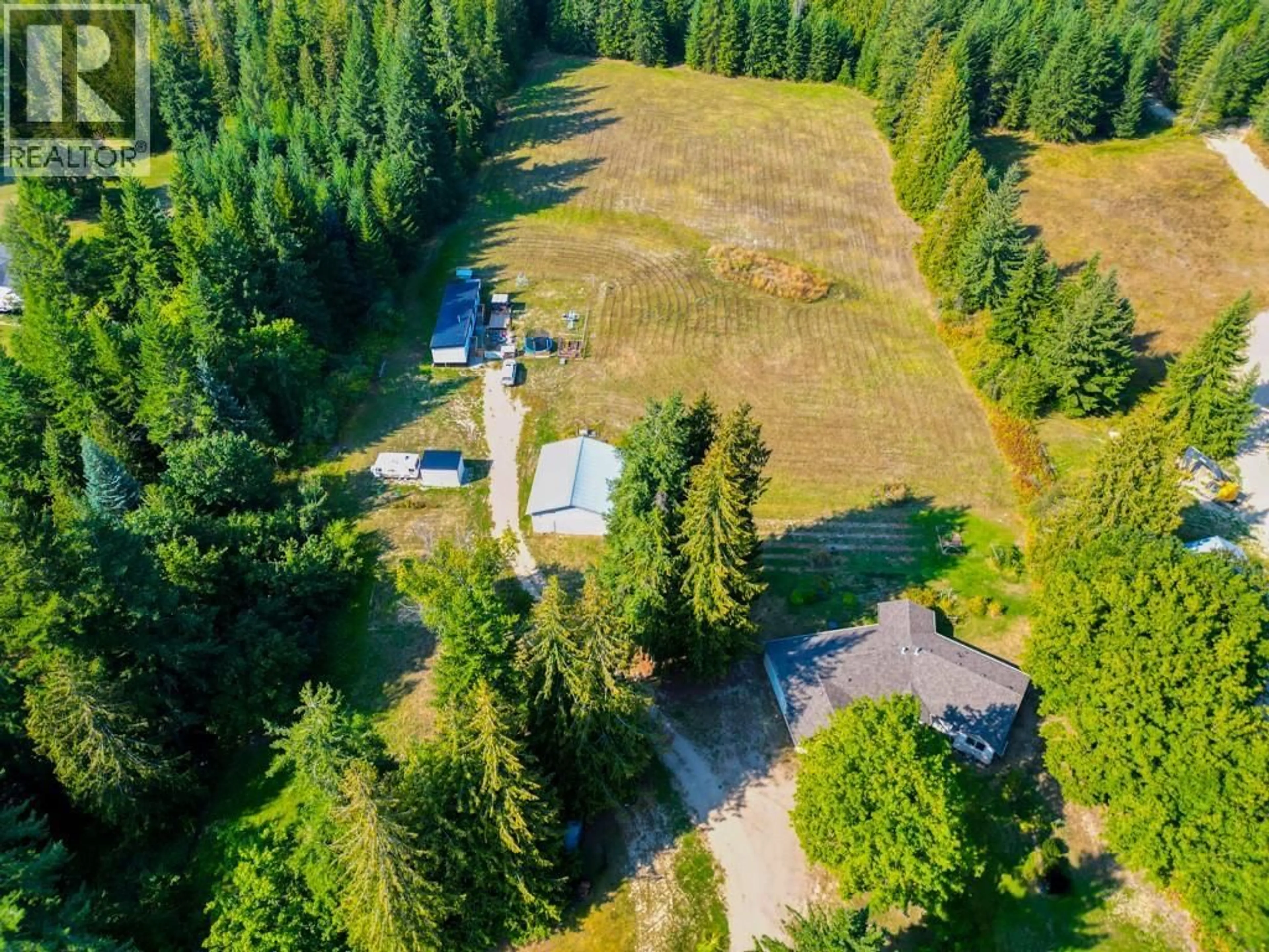 A pic from outside/outdoor area/front of a property/back of a property/a pic from drone, forest/trees view for 4571 50 STREET NORTHEAST, Salmon Arm British Columbia V1E1Y6