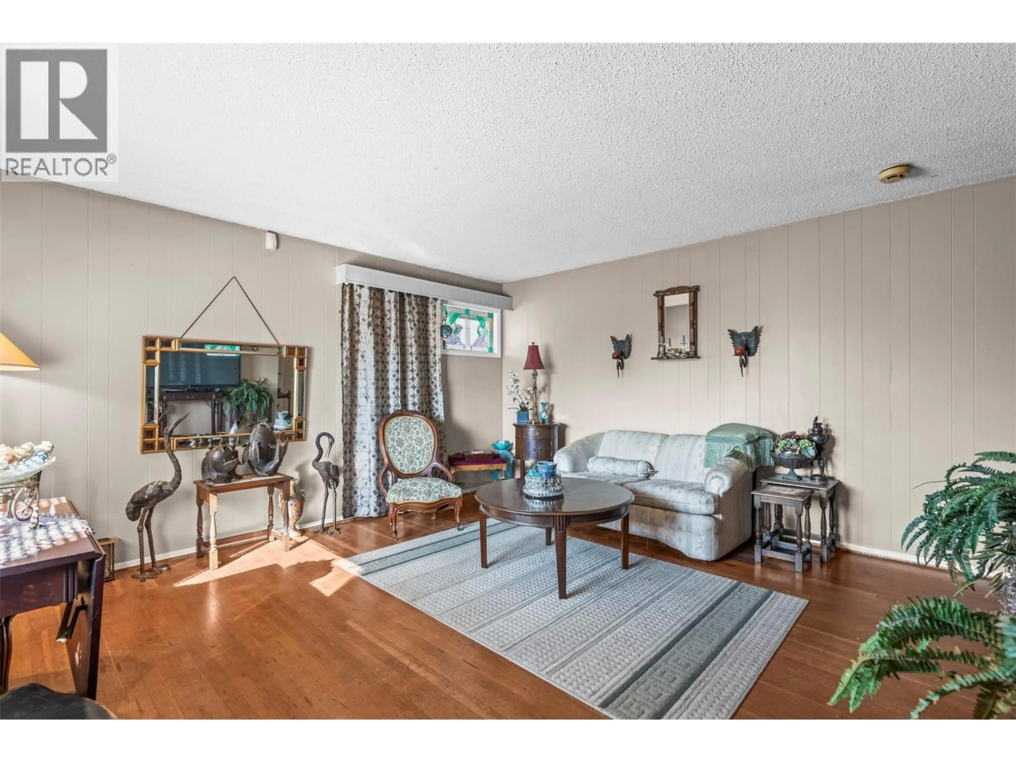 Living room with furniture, wood/laminate floor for 3405 18 STREET, Vernon British Columbia V1T4A8