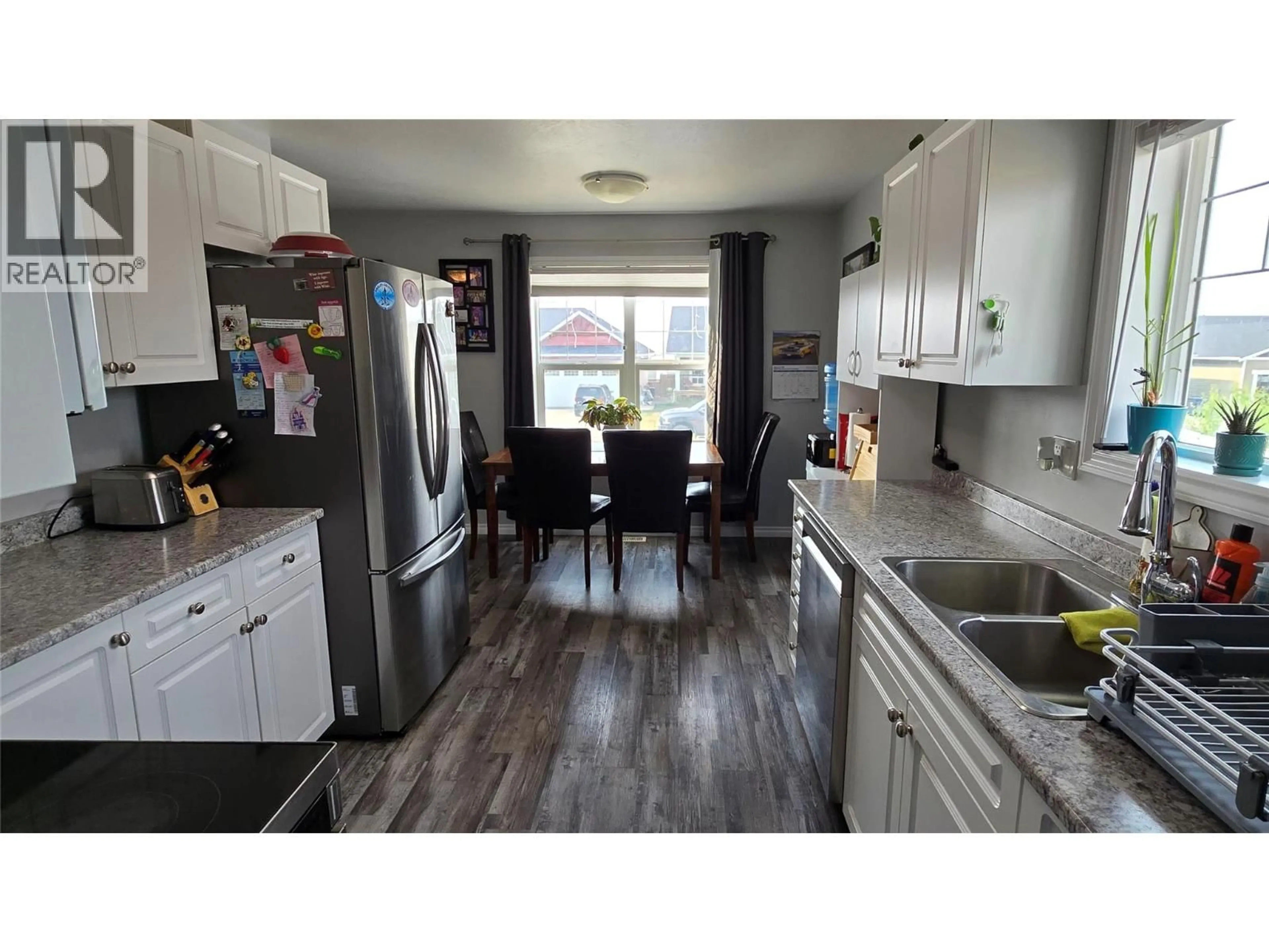 Open concept kitchen, wood/laminate floor for 8208 19A STREET, Dawson Creek British Columbia V1G0J6