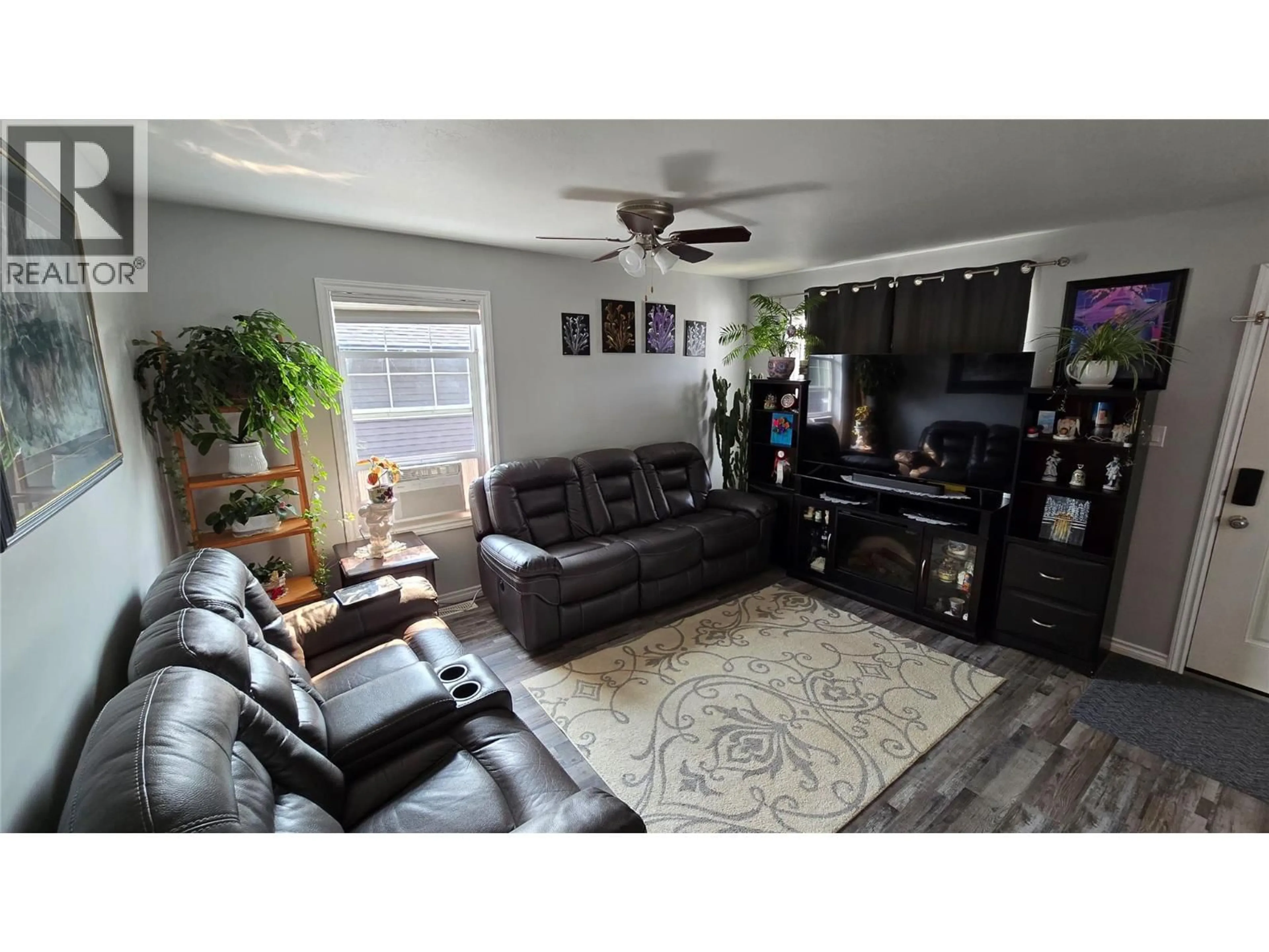 Living room with furniture, wood/laminate floor for 8208 19A STREET, Dawson Creek British Columbia V1G0J6