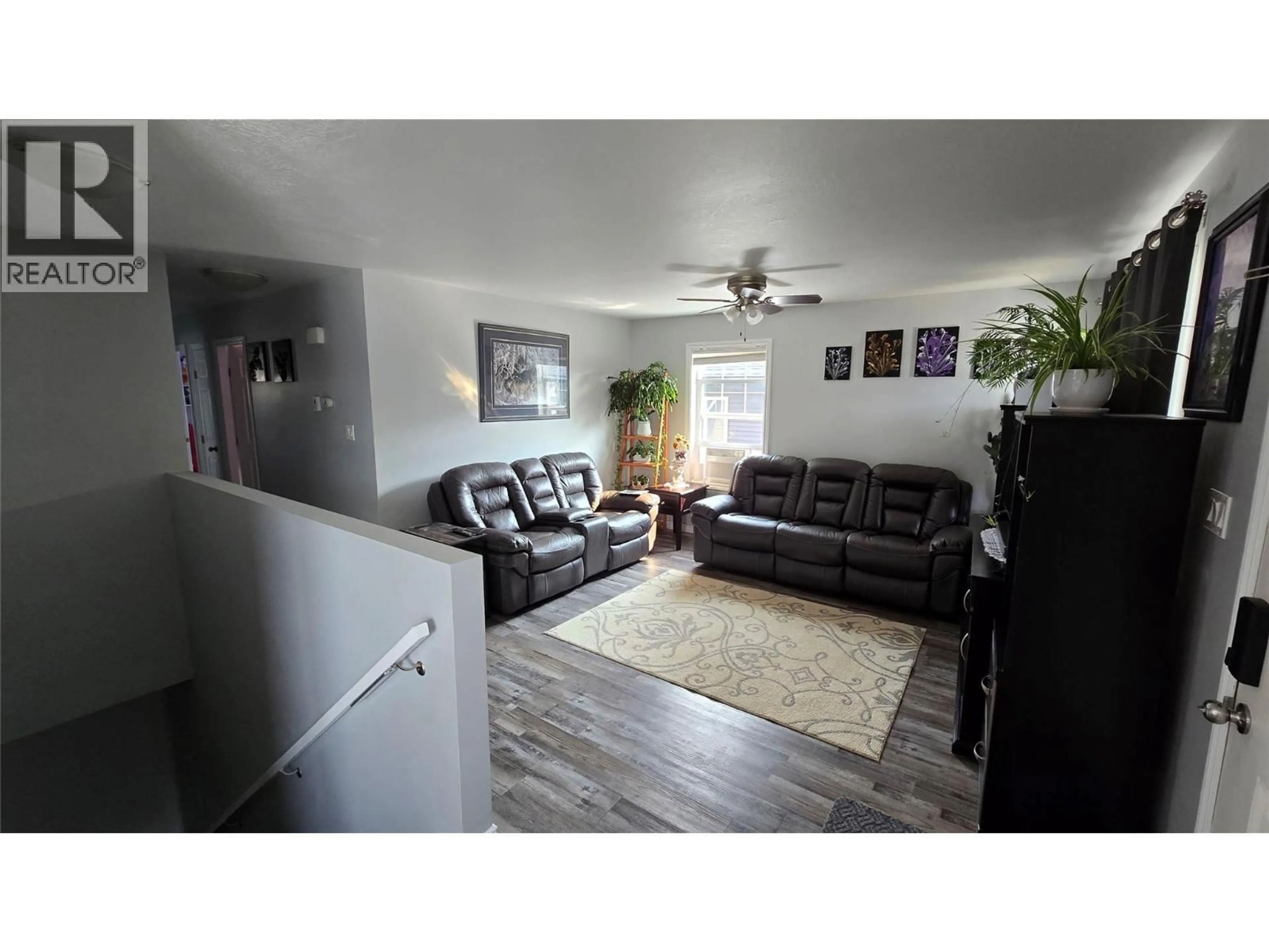 Living room with furniture, wood/laminate floor for 8208 19A STREET, Dawson Creek British Columbia V1G0J6