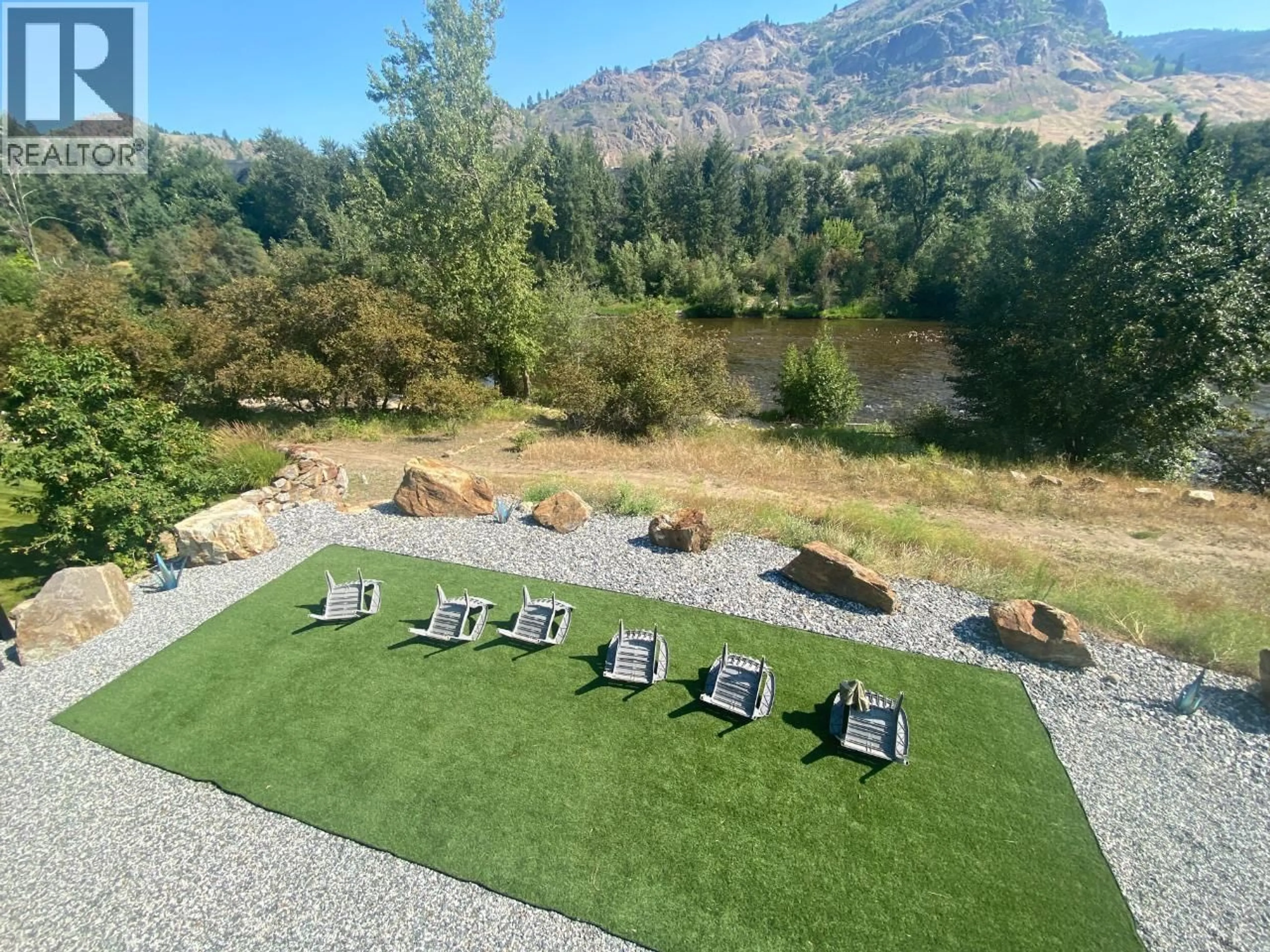 A pic from outside/outdoor area/front of a property/back of a property/a pic from drone, water/lake/river/ocean view for 8660 RIVERSIDE DRIVE, Grand Forks British Columbia V0H1H0