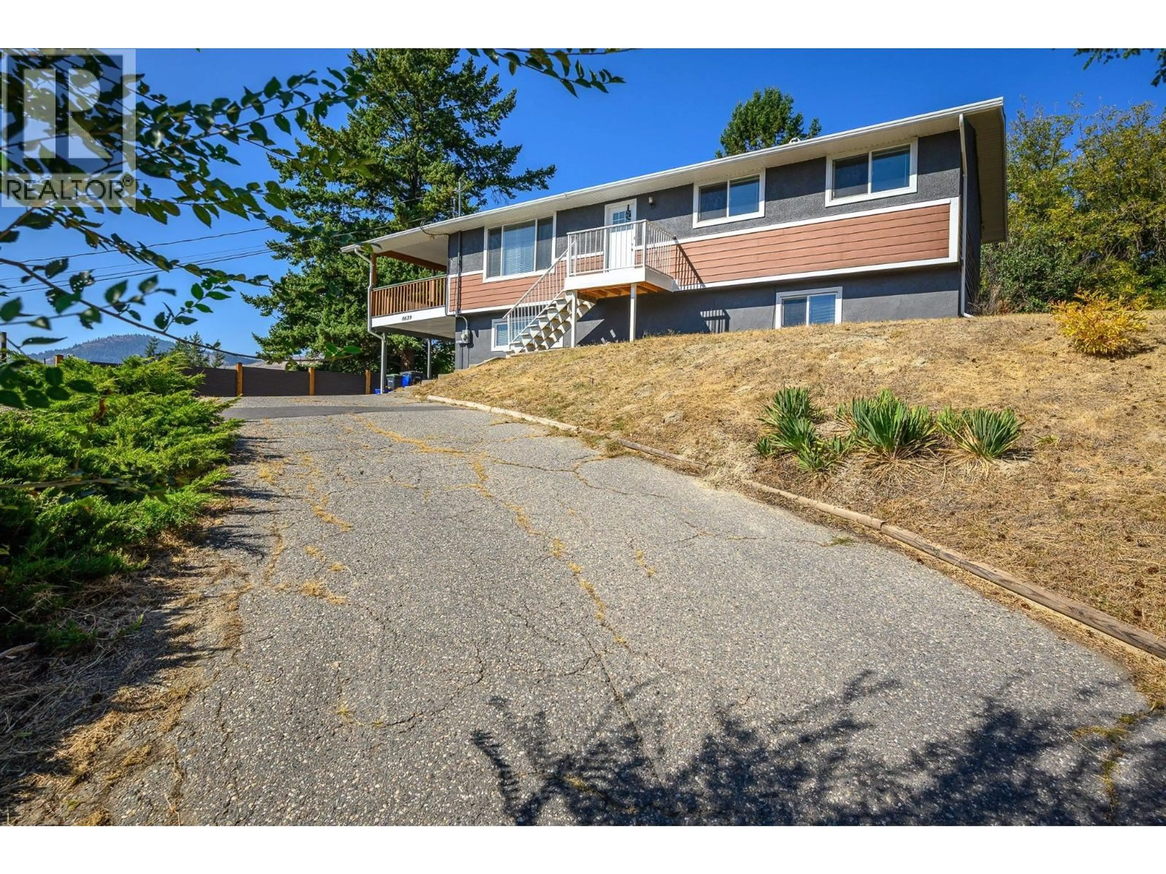 A pic from outside/outdoor area/front of a property/back of a property/a pic from drone, street for 6639 TOPAZ ROAD, Vernon British Columbia V1H1N8