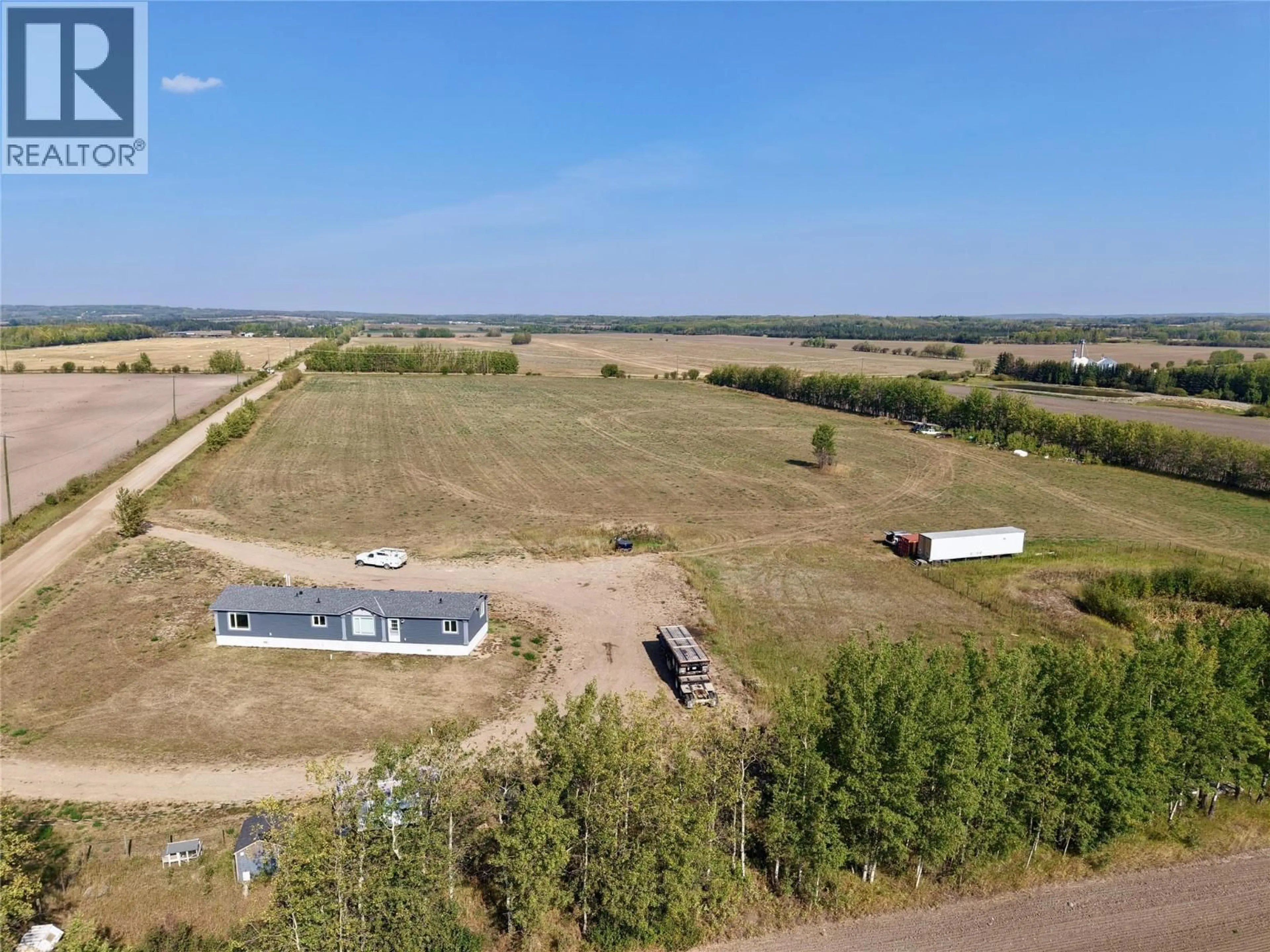 A pic from outside/outdoor area/front of a property/back of a property/a pic from drone, water/lake/river/ocean view for 15243 209 ROAD, Dawson Creek British Columbia V0C2L0