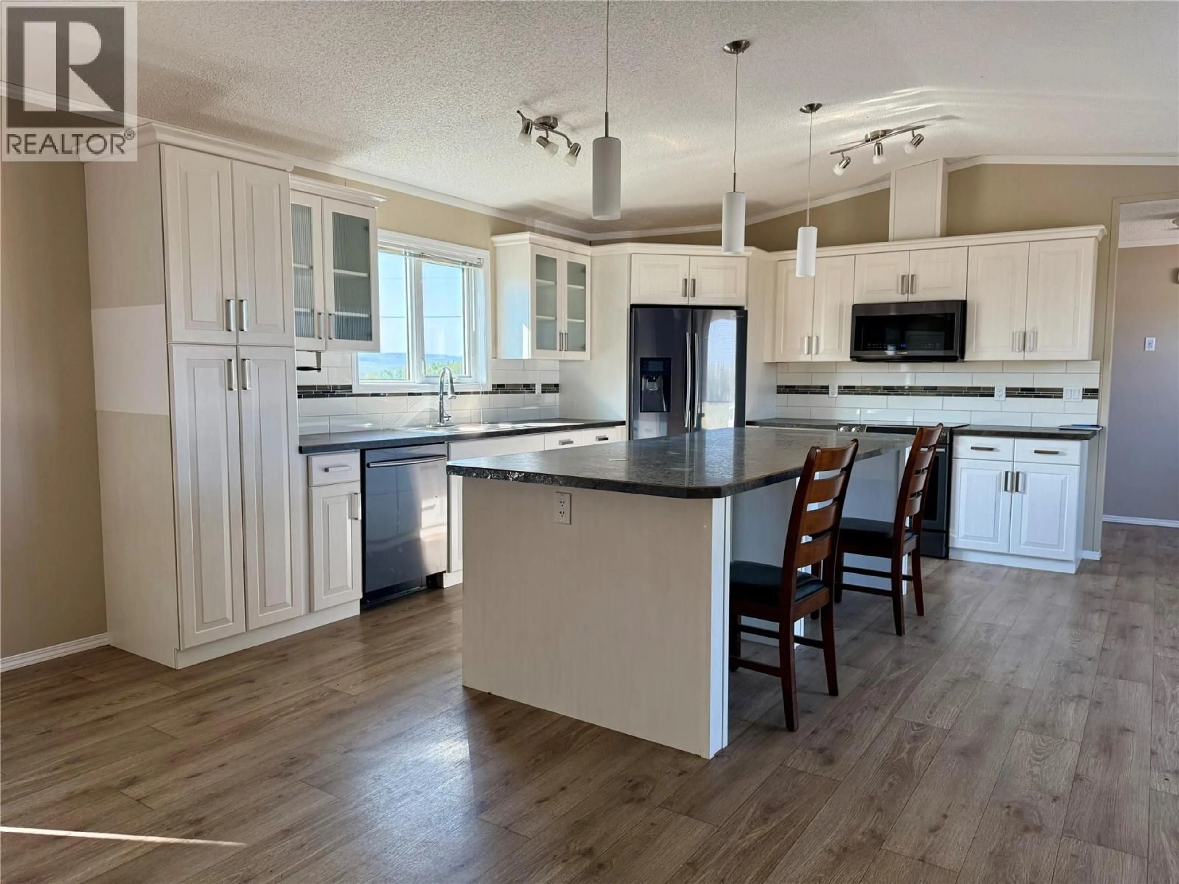 Open concept kitchen, wood/laminate floor for 15243 209 ROAD, Dawson Creek British Columbia V0C2L0