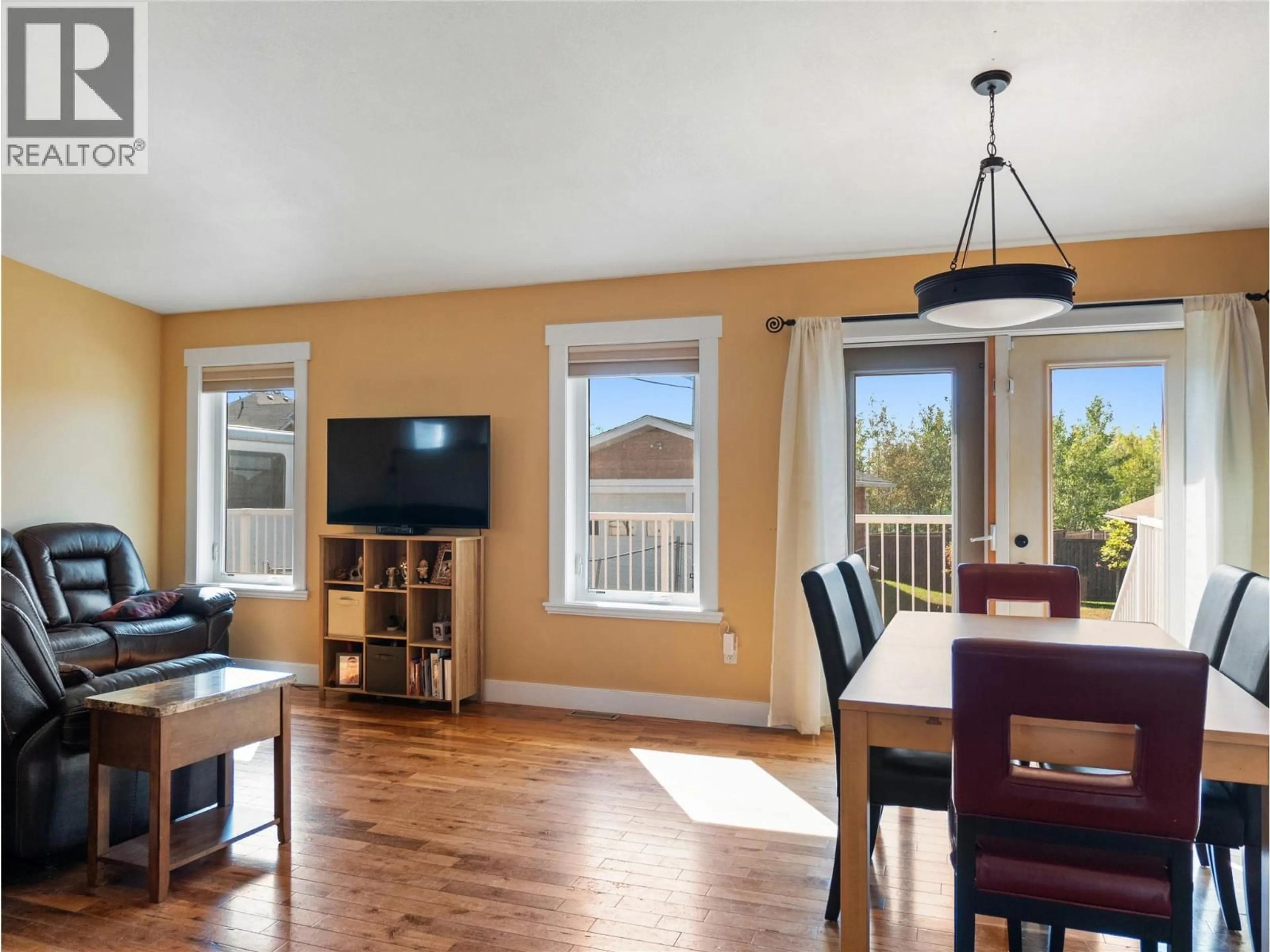 Living room with furniture, wood/laminate floor for 1701 87 AVENUE, Dawson Creek British Columbia V1G0B2