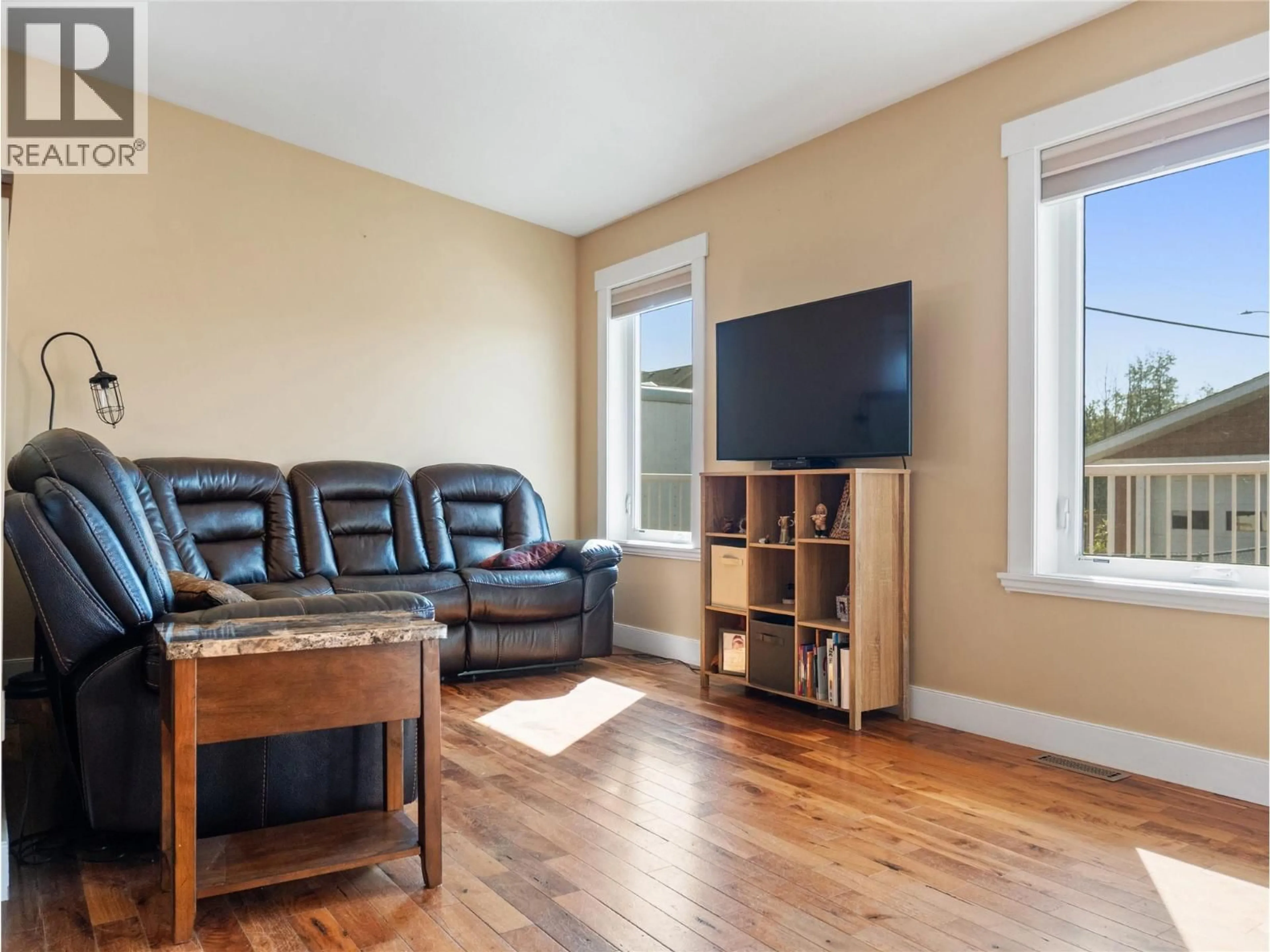 Living room with furniture, wood/laminate floor for 1701 87 AVENUE, Dawson Creek British Columbia V1G0B2