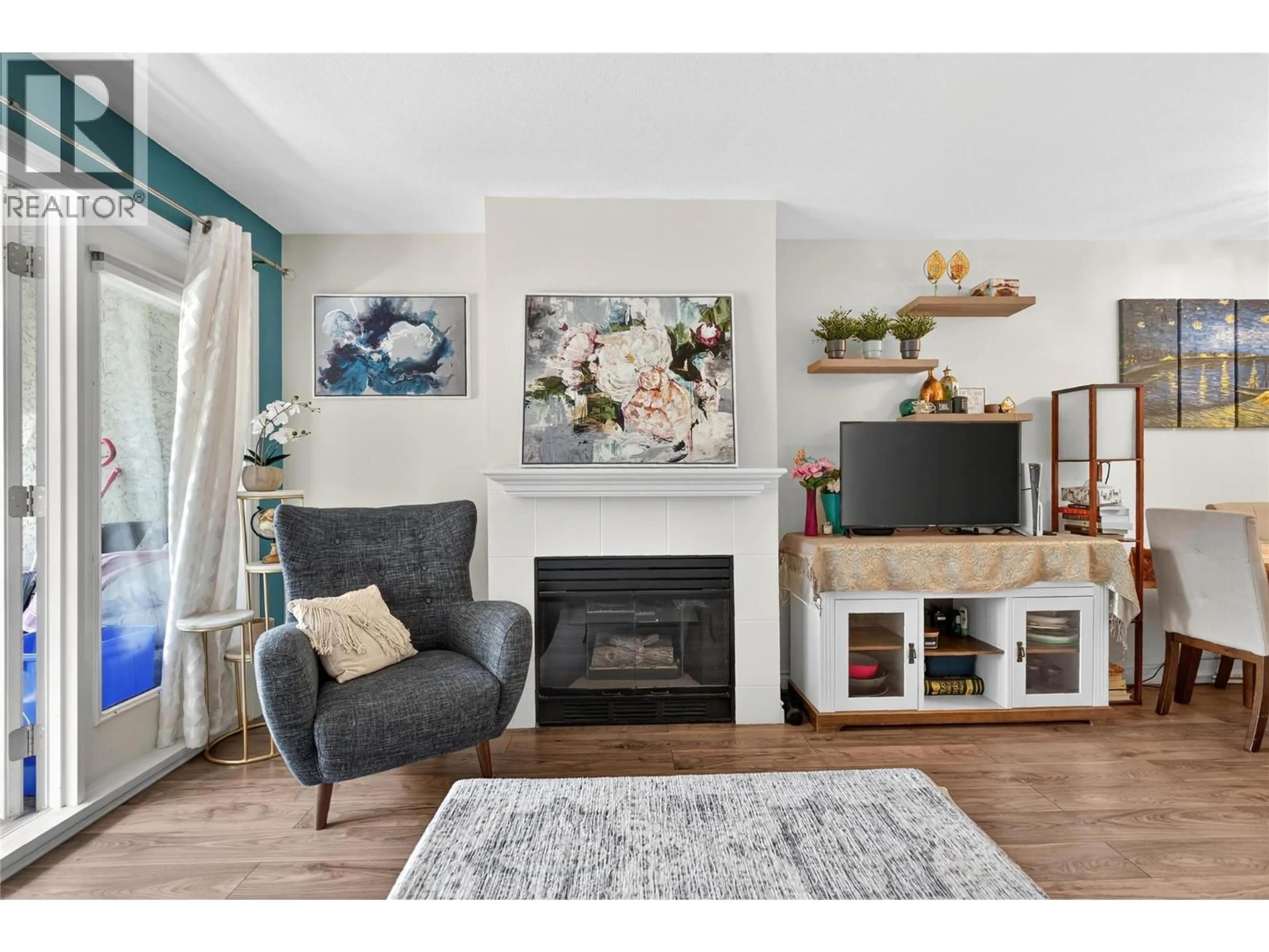 Living room with furniture, wood/laminate floor for 412 - 3175 DE MONTREUIL COURT, Kelowna British Columbia V1W3W2