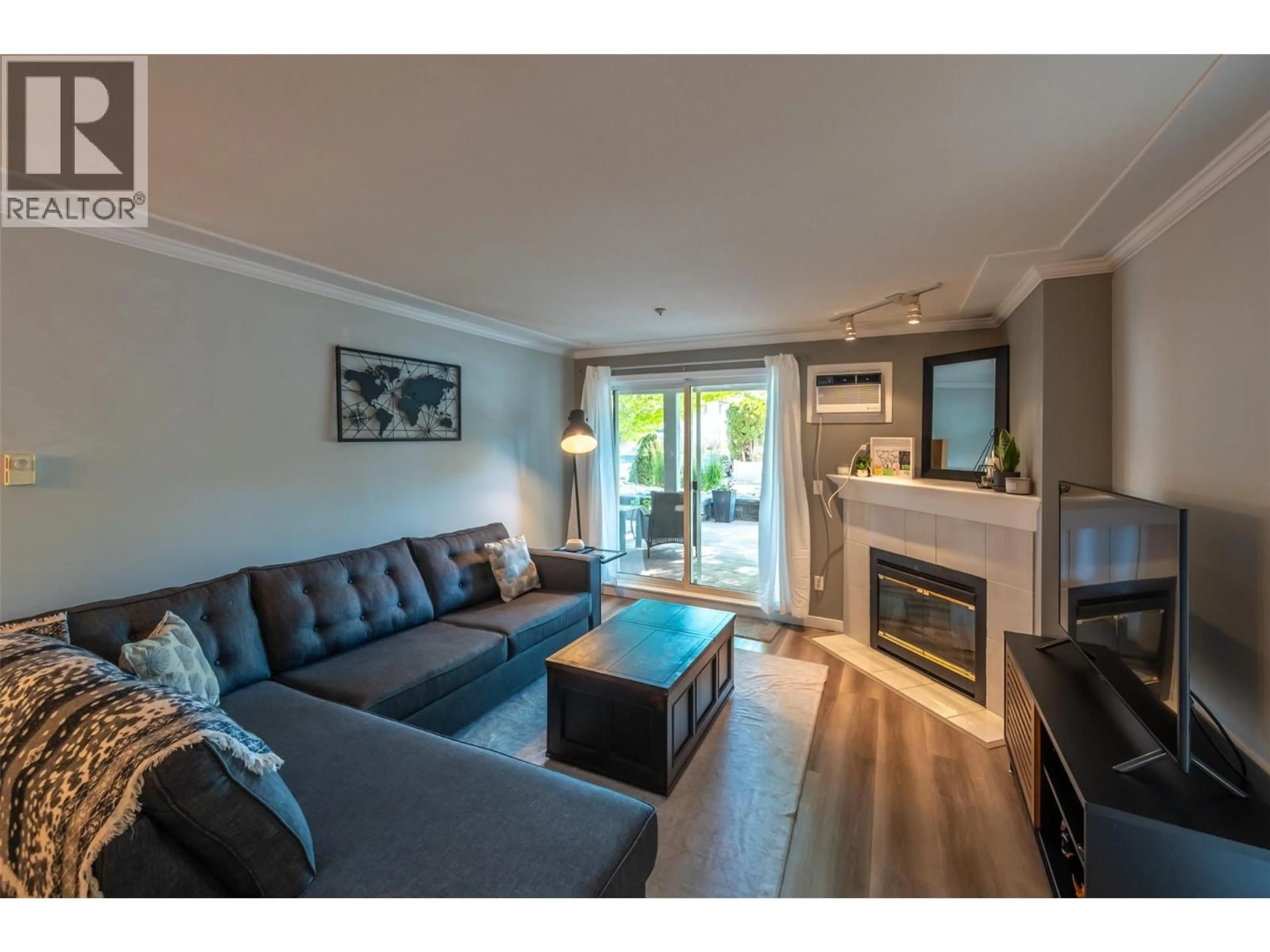 Living room with furniture, wood/laminate floor for 109 - 329 RIGSBY STREET, Penticton British Columbia V2A5S6