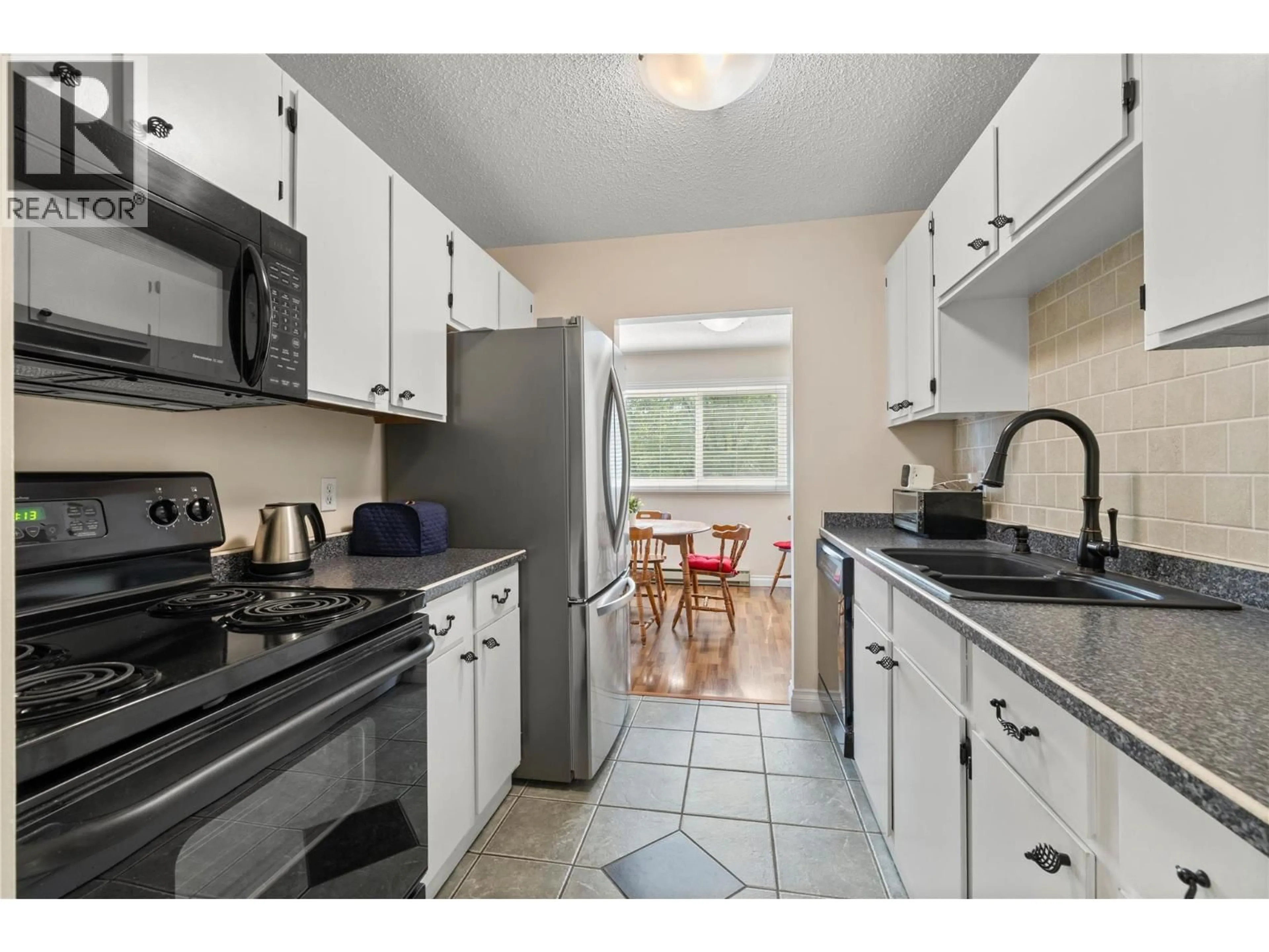 Standard kitchen, ceramic/tile floor for 205 - 1860 RICHTER STREET, Kelowna British Columbia V1Y2M9