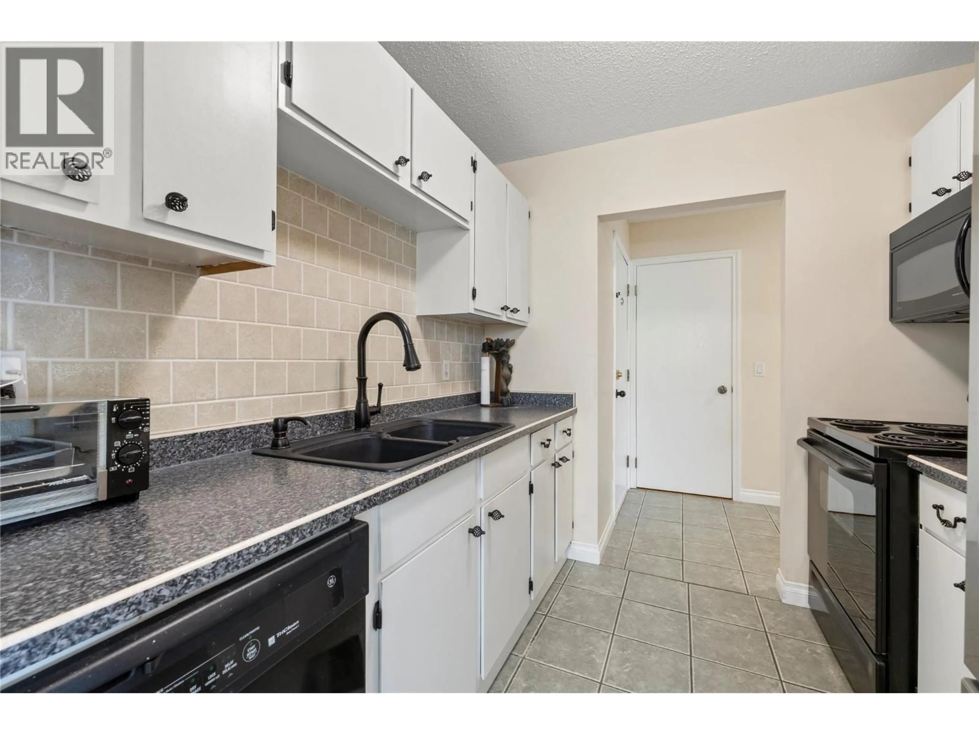 Standard kitchen, ceramic/tile floor for 205 - 1860 RICHTER STREET, Kelowna British Columbia V1Y2M9