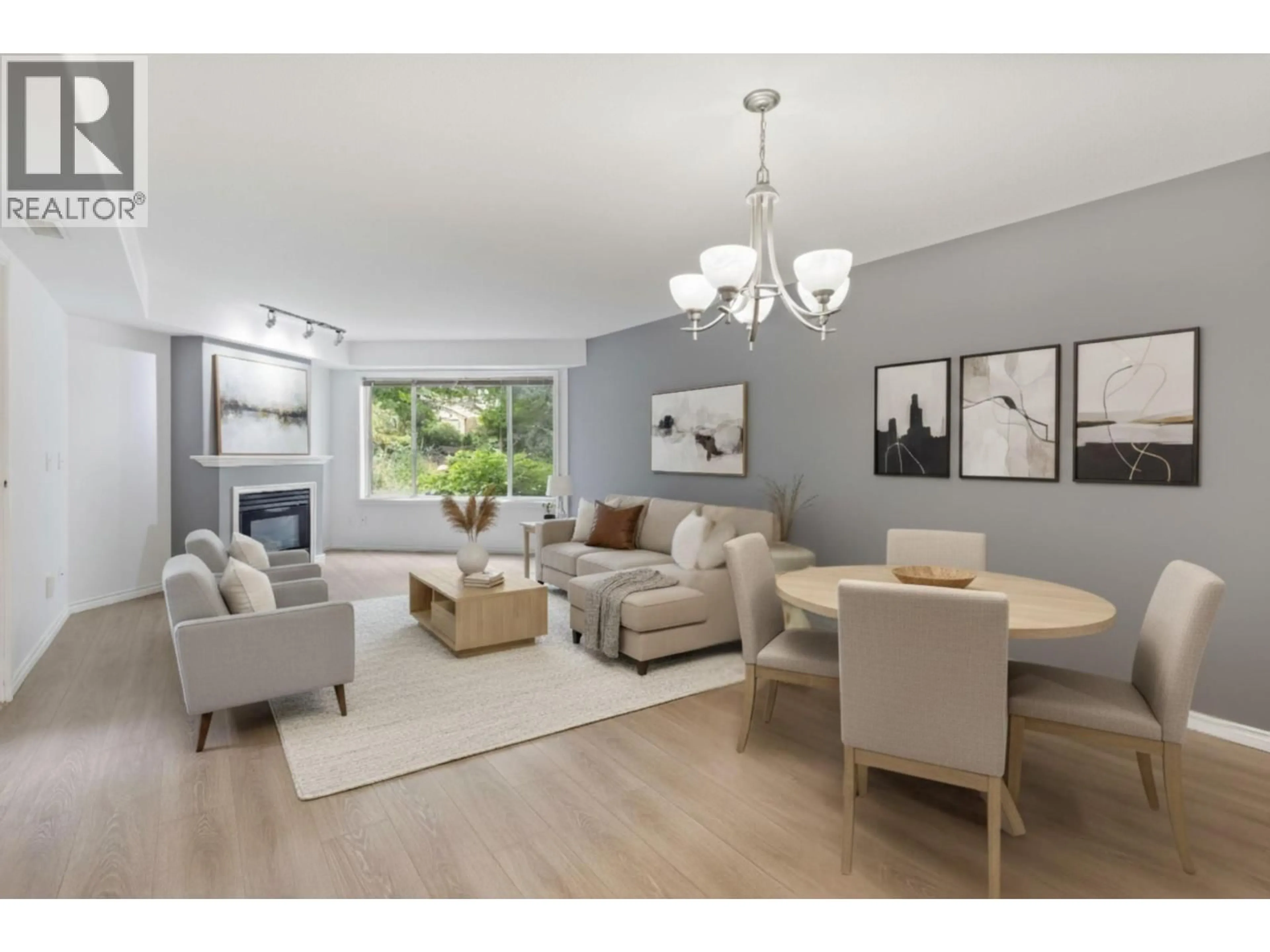Living room with furniture, wood/laminate floor for 101 - 265 SNOWSELL STREET, Kelowna British Columbia V1V1V6