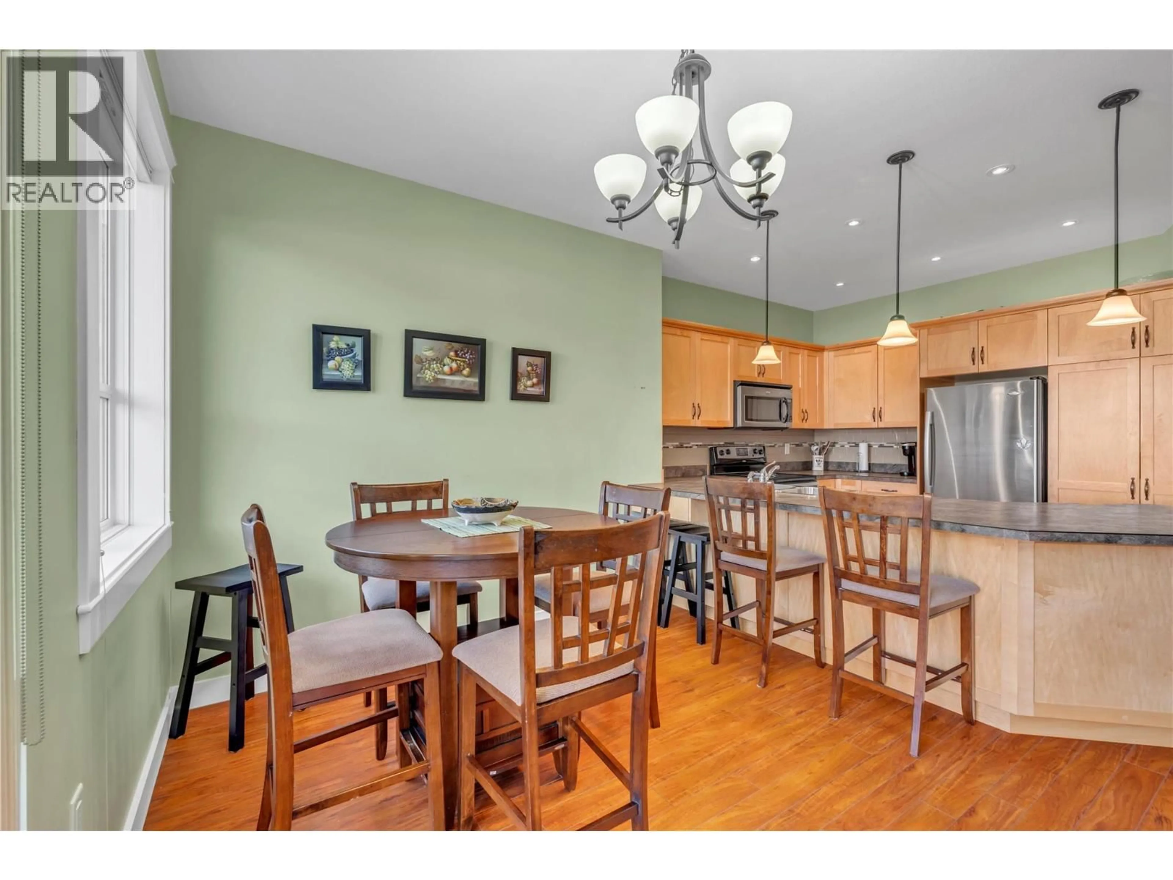 Open concept kitchen, wood/laminate floor for 102 - 379 DOUGLAS AVENUE, Penticton British Columbia V0H1Z0