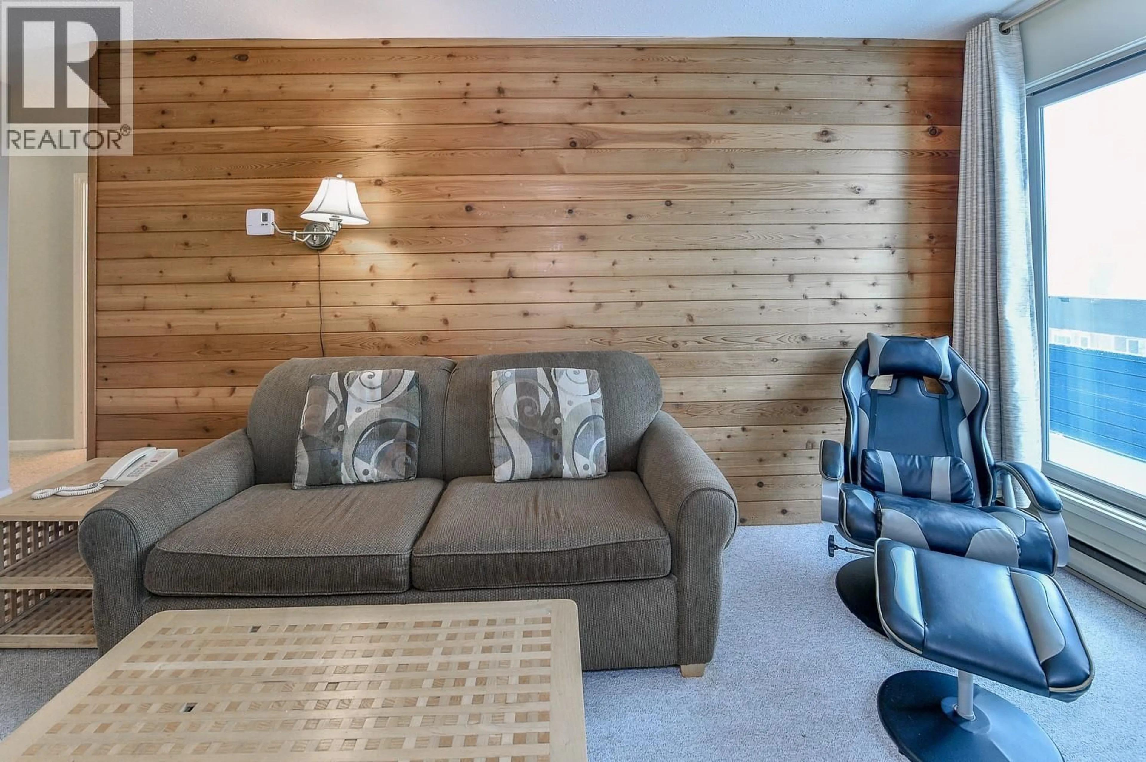Living room with furniture, wood/laminate floor for 205 - 6430 WHISKEY JACK ROAD, Big White British Columbia V0H1A0
