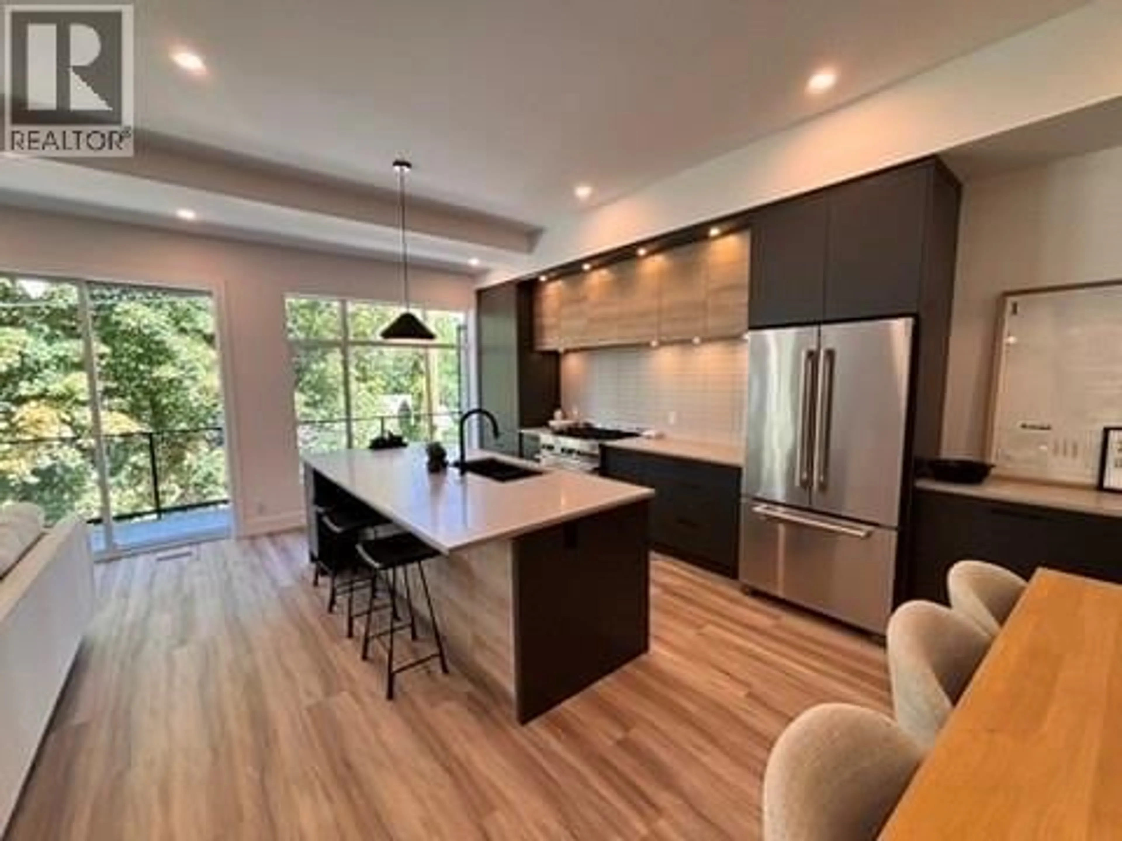 Open concept kitchen, wood/laminate floor for 5 - 7920 KIDSTON ROAD, Coldstream British Columbia V1B0B4