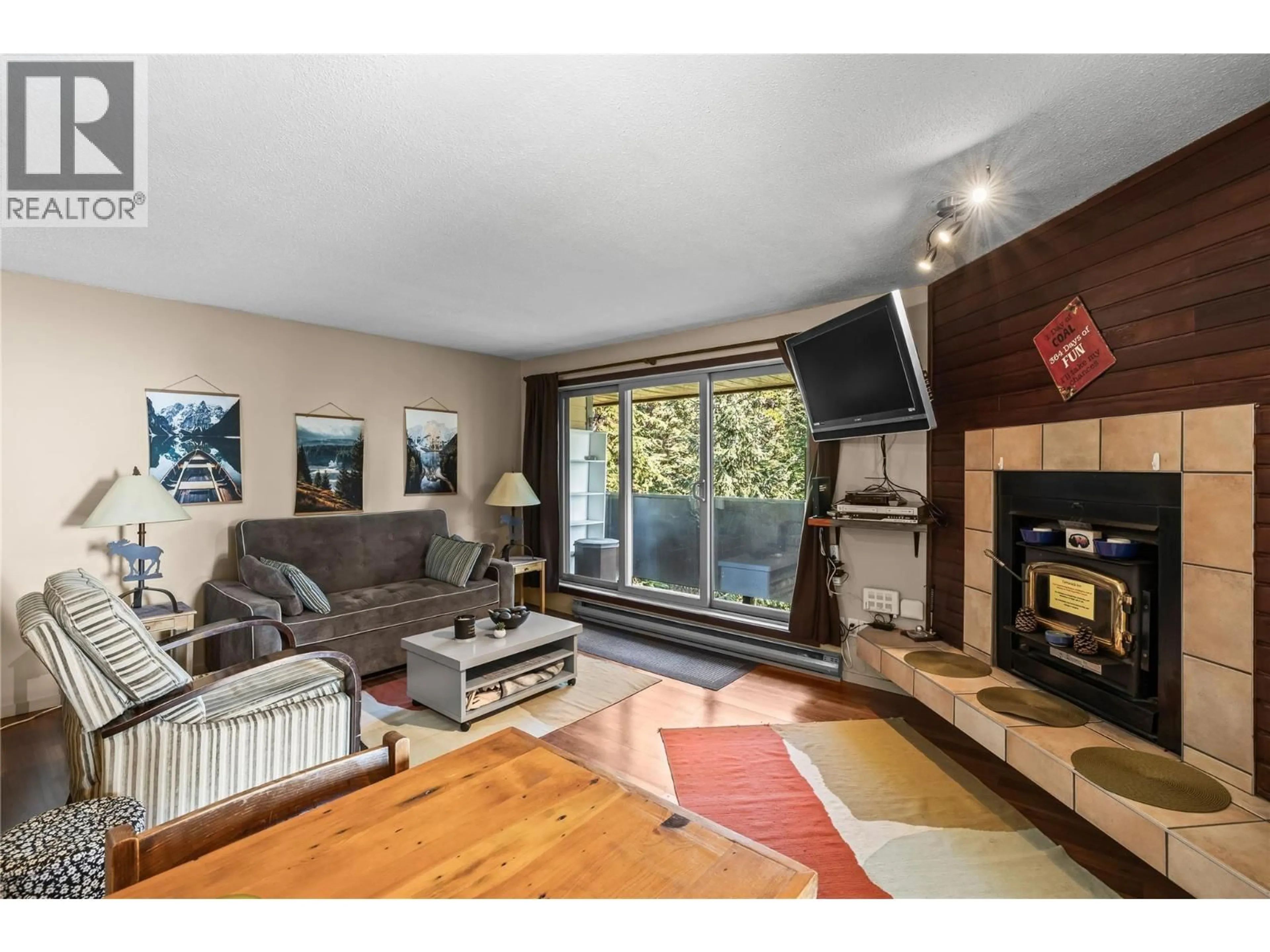 Living room with furniture, wood/laminate floor for 308 - 6375 WHISKEY JACK ROAD, Big White British Columbia V1P1P3