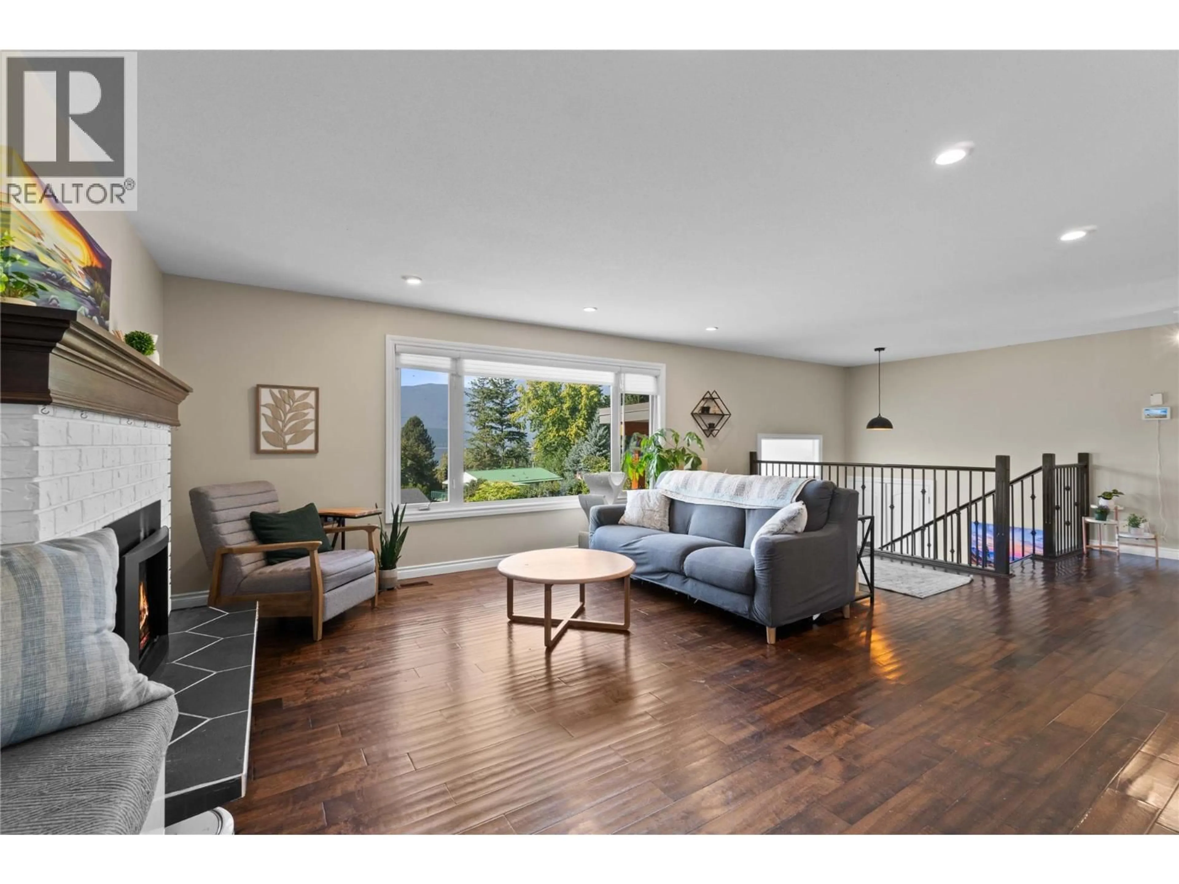 Living room with furniture, wood/laminate floor for 1780 16 STREET NORTHEAST, Salmon Arm British Columbia V1E3Z8