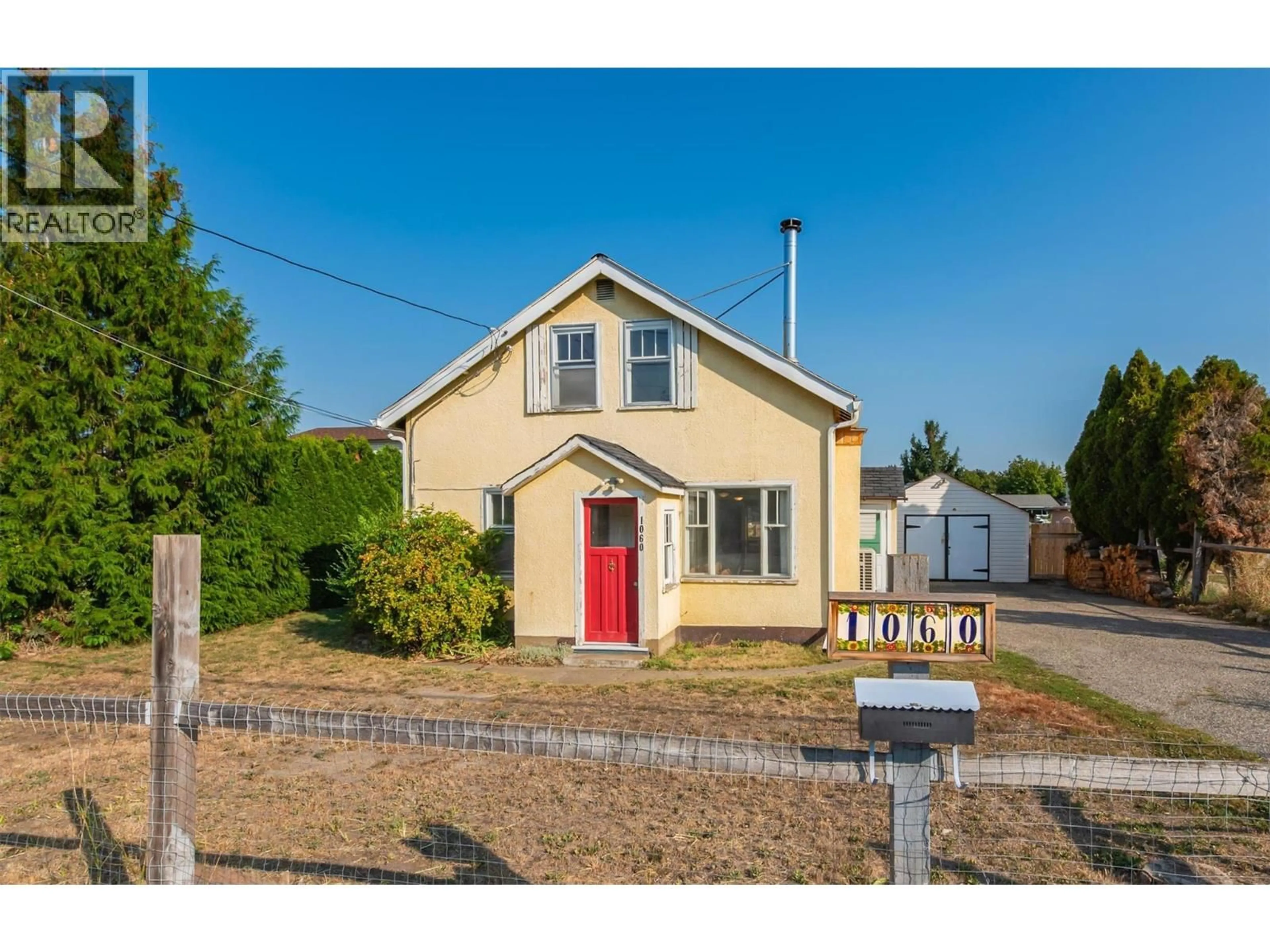 A pic from outside/outdoor area/front of a property/back of a property/a pic from drone, street for 1060 TATARYN ROAD, Kelowna British Columbia V1X1N8