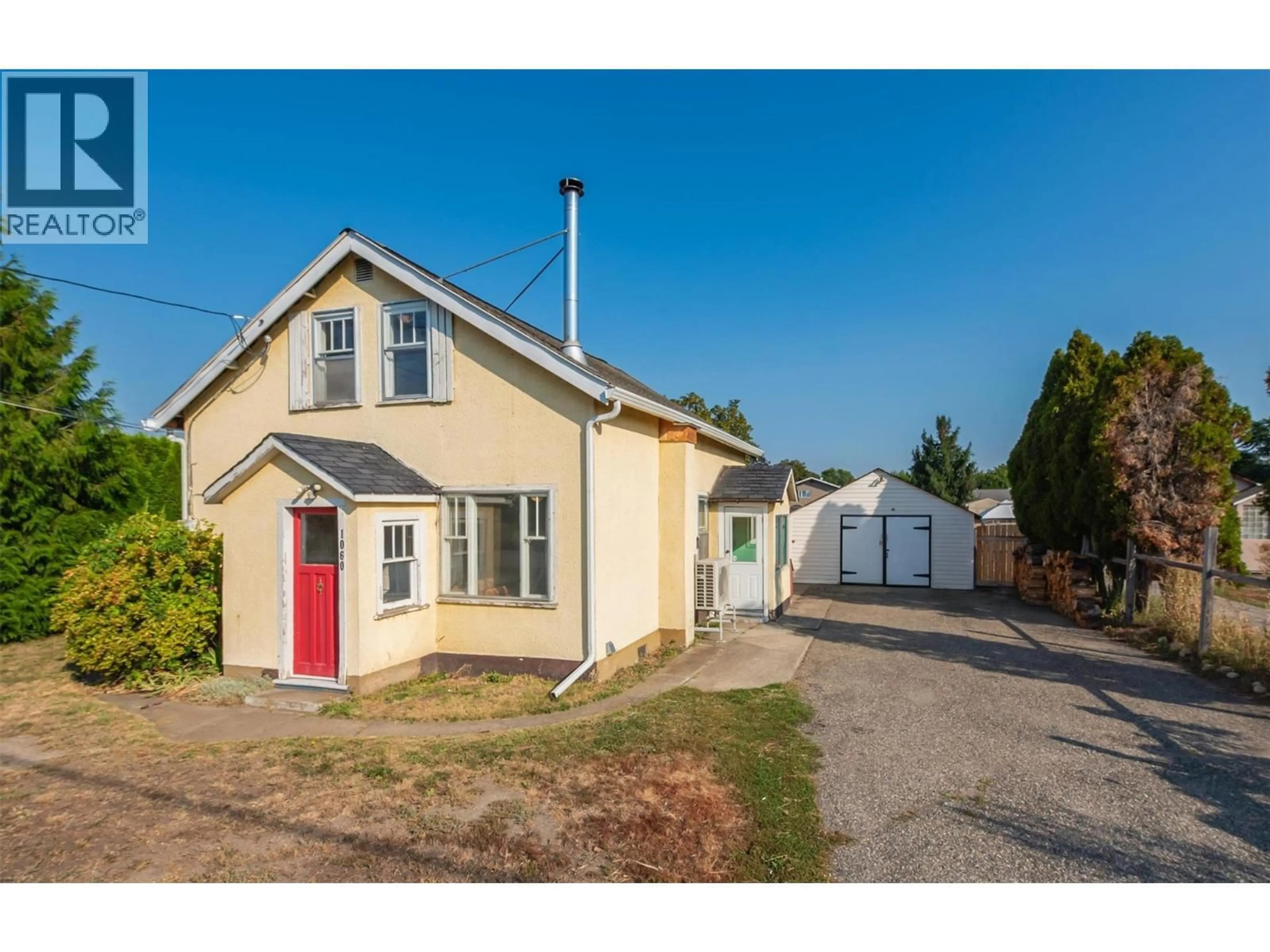 A pic from outside/outdoor area/front of a property/back of a property/a pic from drone, street for 1060 TATARYN ROAD, Kelowna British Columbia V1X1N8