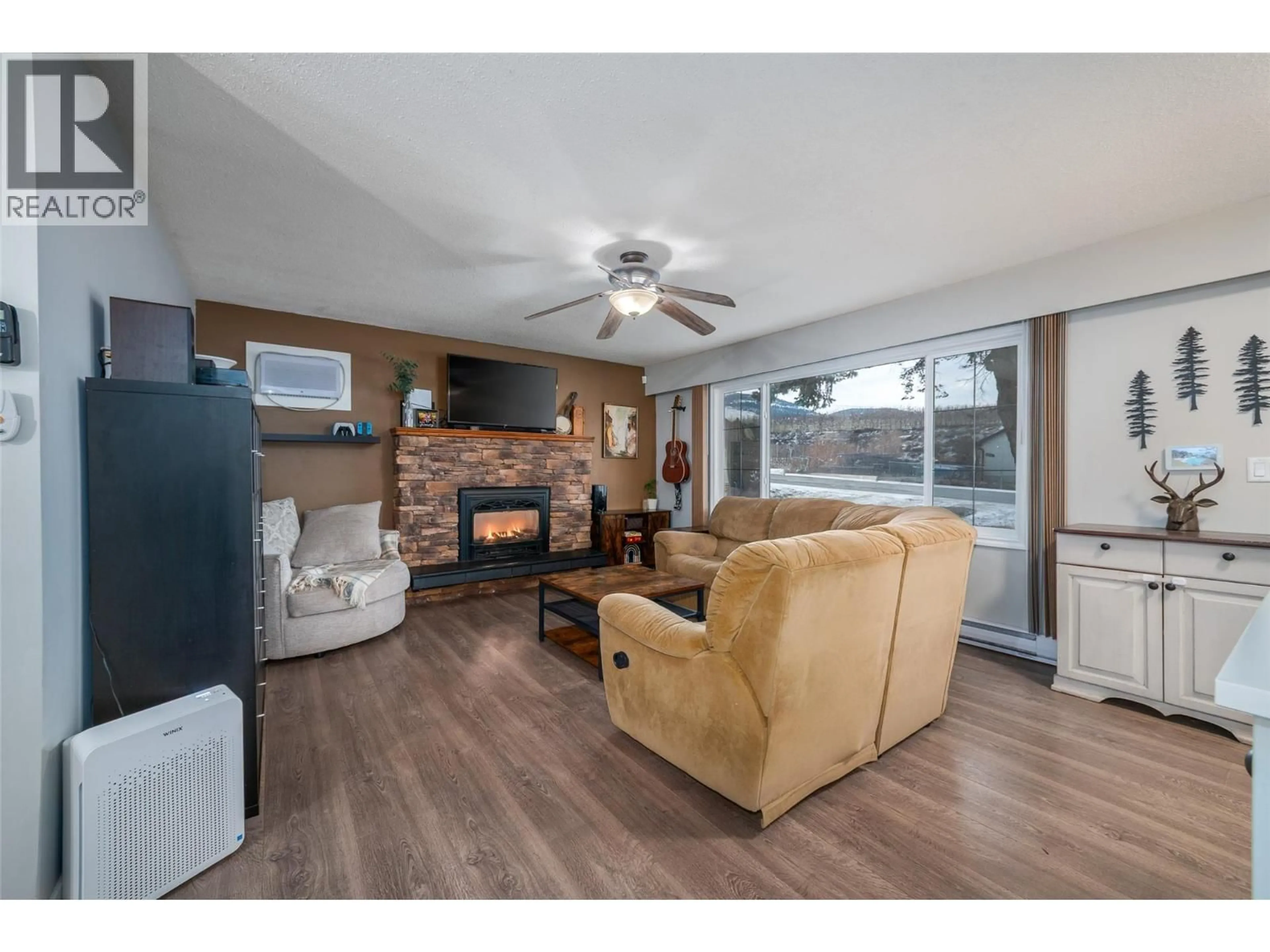 Living room with furniture, wood/laminate floor for 4840 SCOTTY CREEK ROAD, Kelowna British Columbia V1X6J8