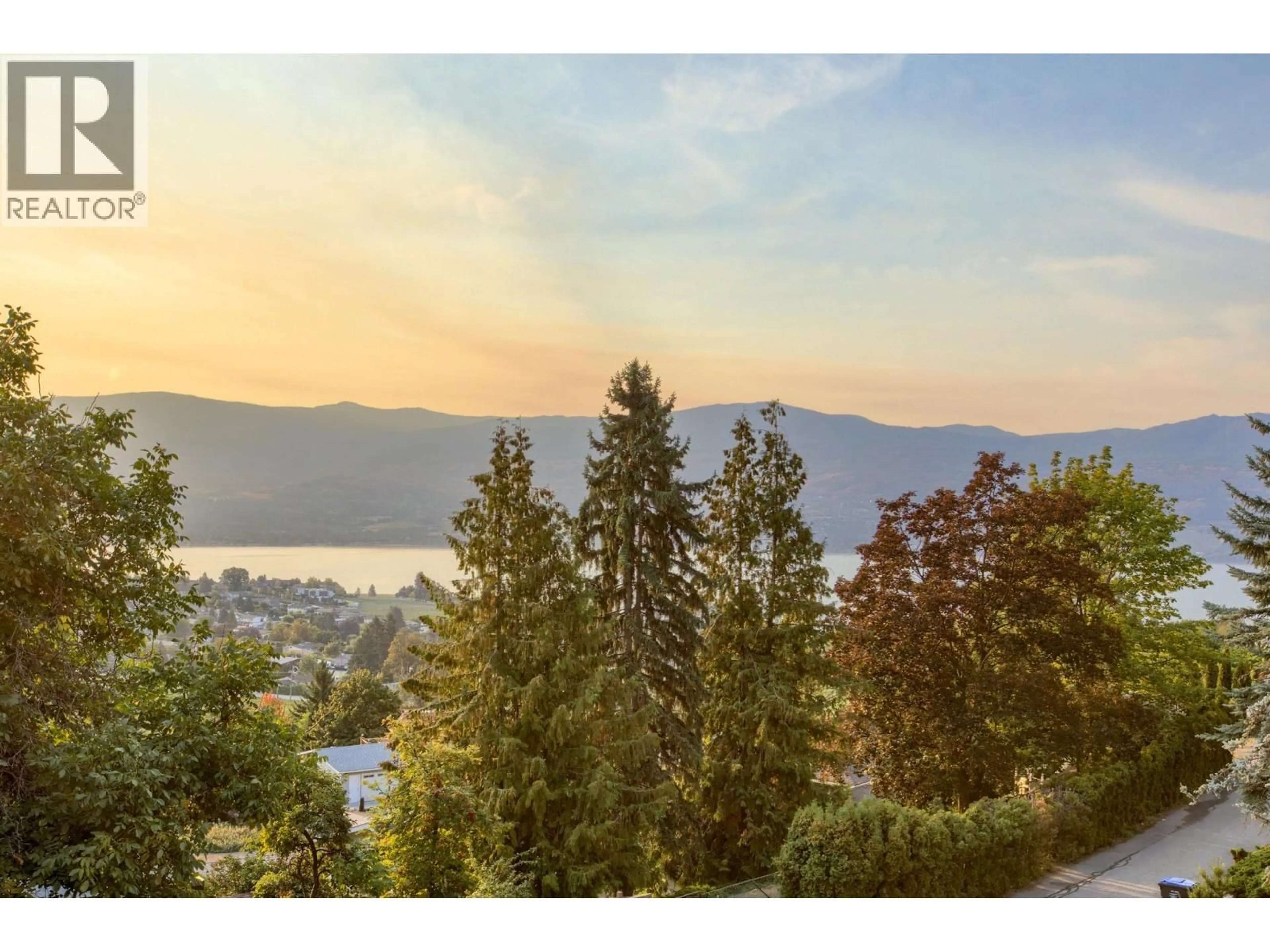 A pic from outside/outdoor area/front of a property/back of a property/a pic from drone, mountain view for 1201 TREVOR DRIVE, West Kelowna British Columbia V1Z3K7