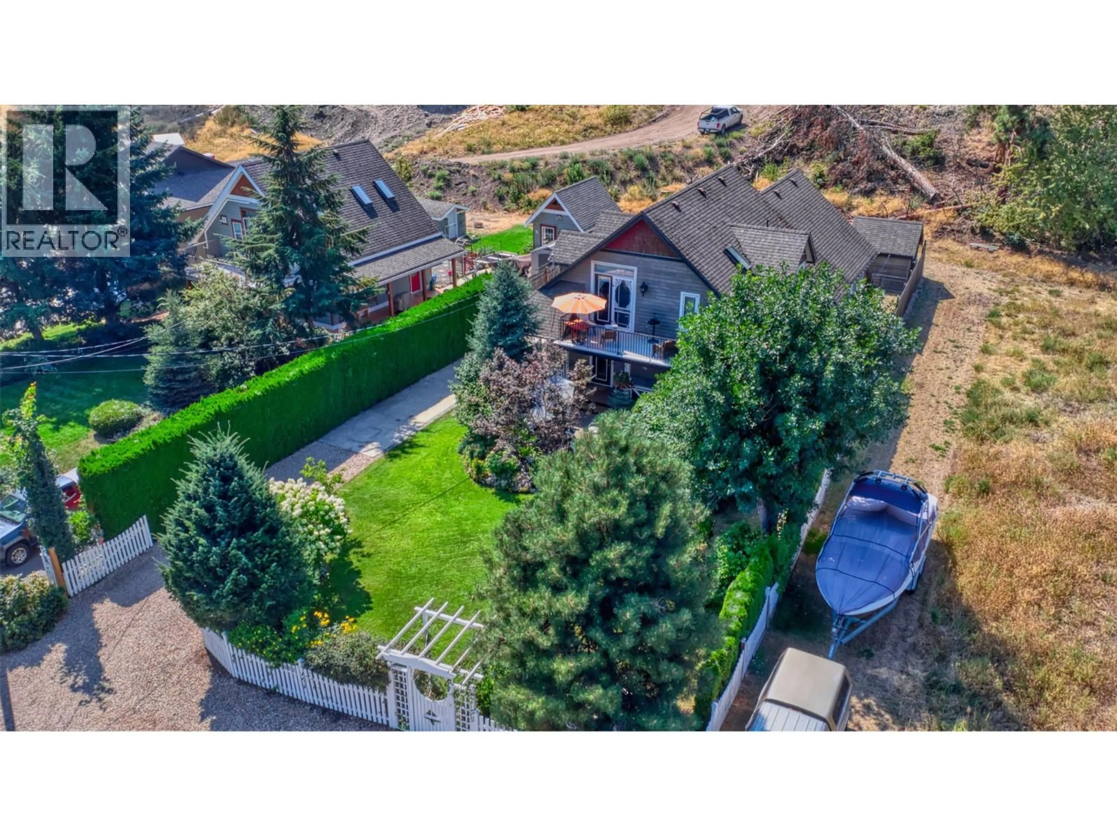 A pic from outside/outdoor area/front of a property/back of a property/a pic from drone, street for 7372 FINTRY DELTA ROAD, Kelowna British Columbia V1Z3V2