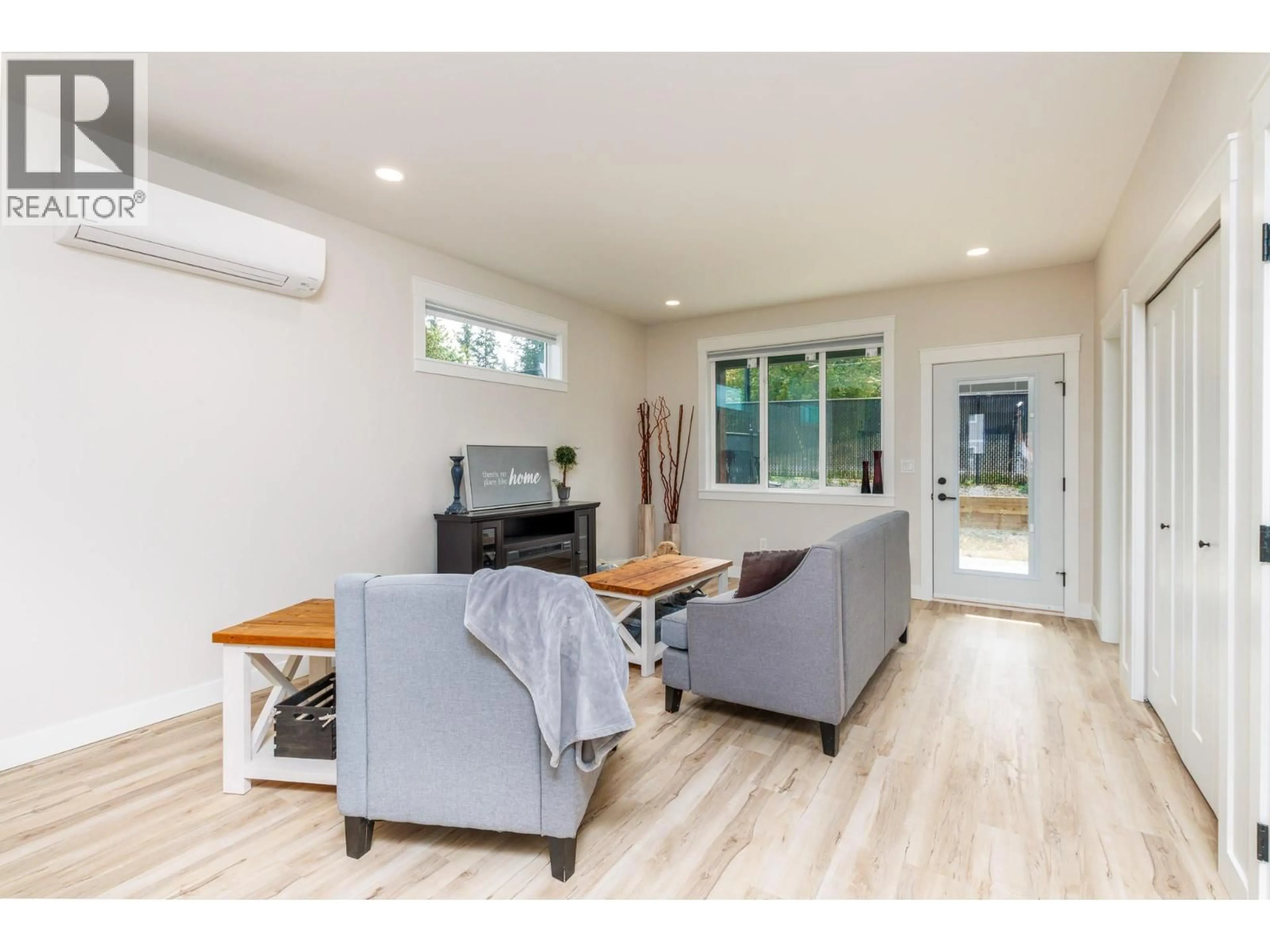 Living room with furniture, wood/laminate floor for 2374 6 AVENUE SOUTHEAST, Salmon Arm British Columbia V1E0H1