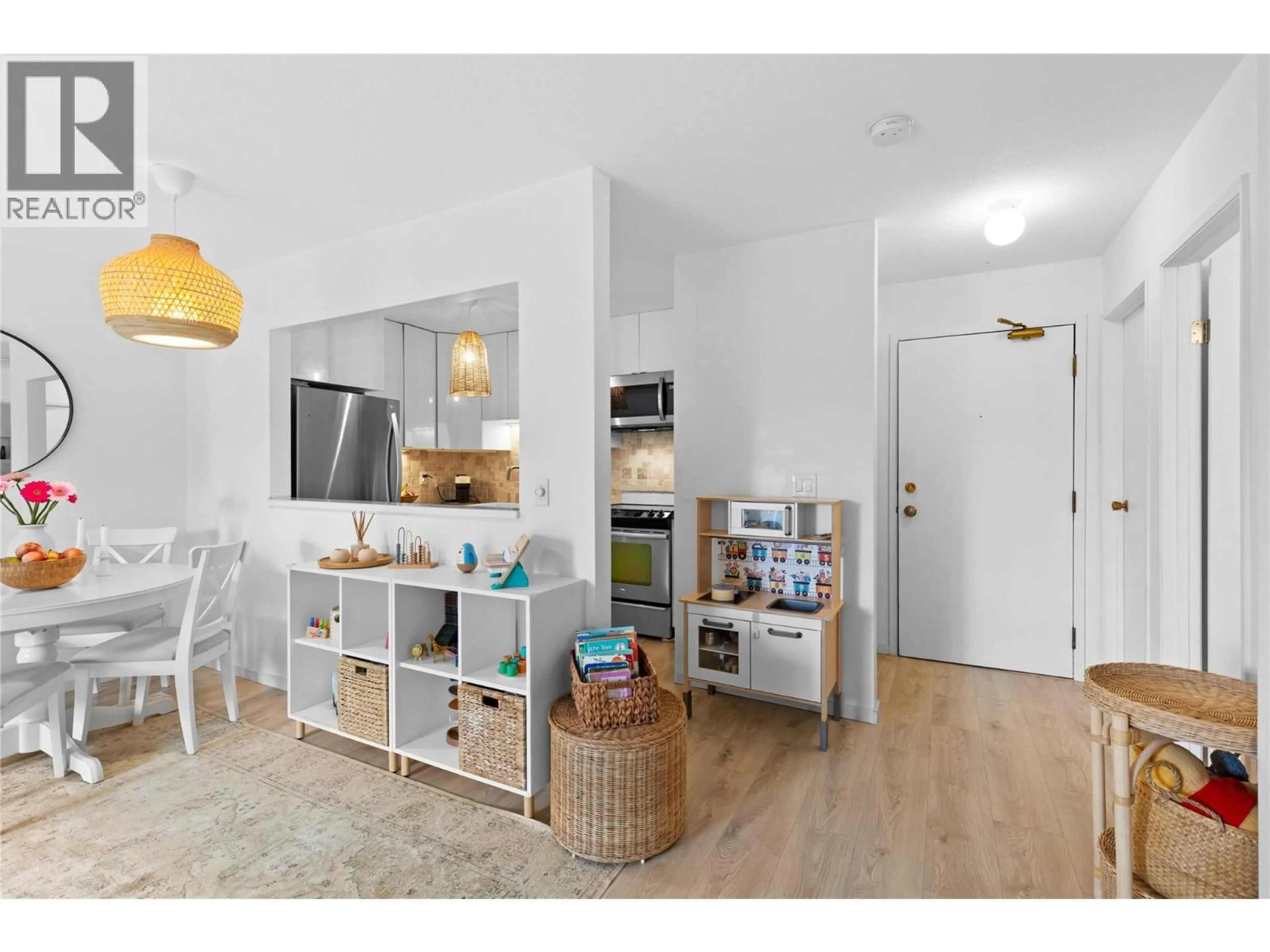 Open concept kitchen, wood/laminate floor for 406 - 3160 DE MONTREUIL COURT, Kelowna British Columbia V1W3W3