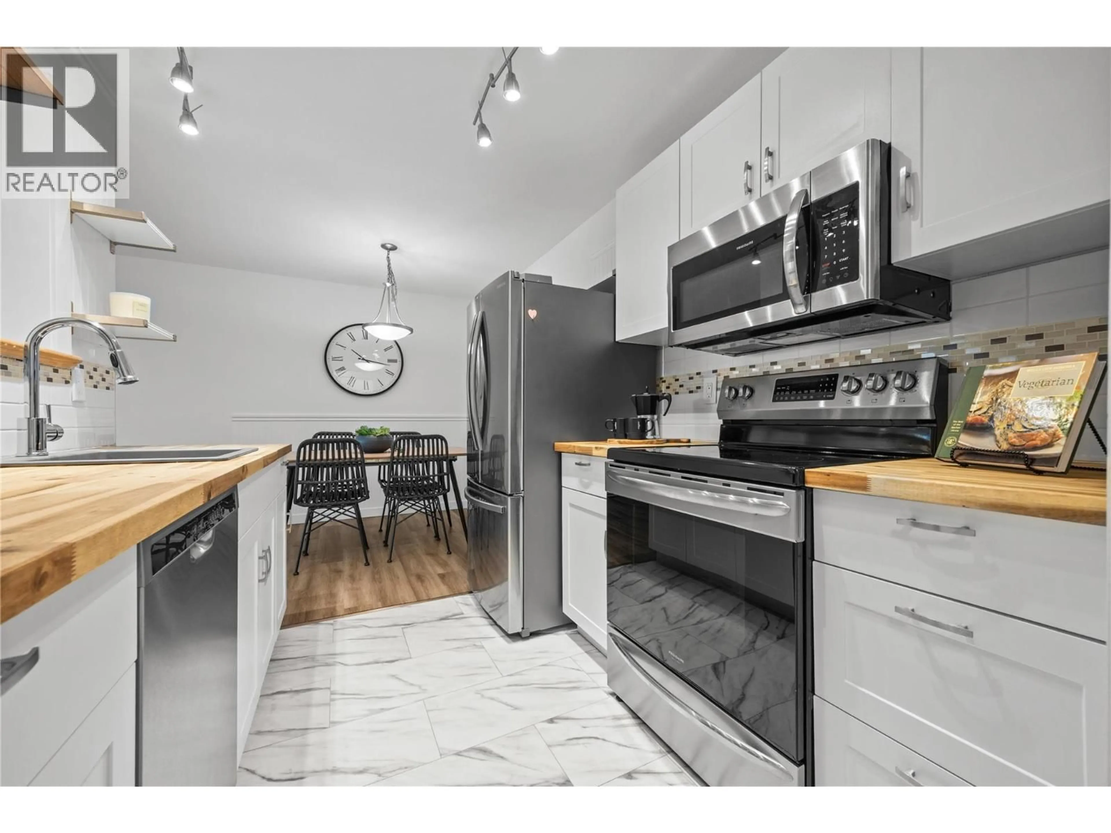 Open concept kitchen, wood/laminate floor for 310 - 3180 DE MONTREUIL COURT, Kelowna British Columbia V1W3W4