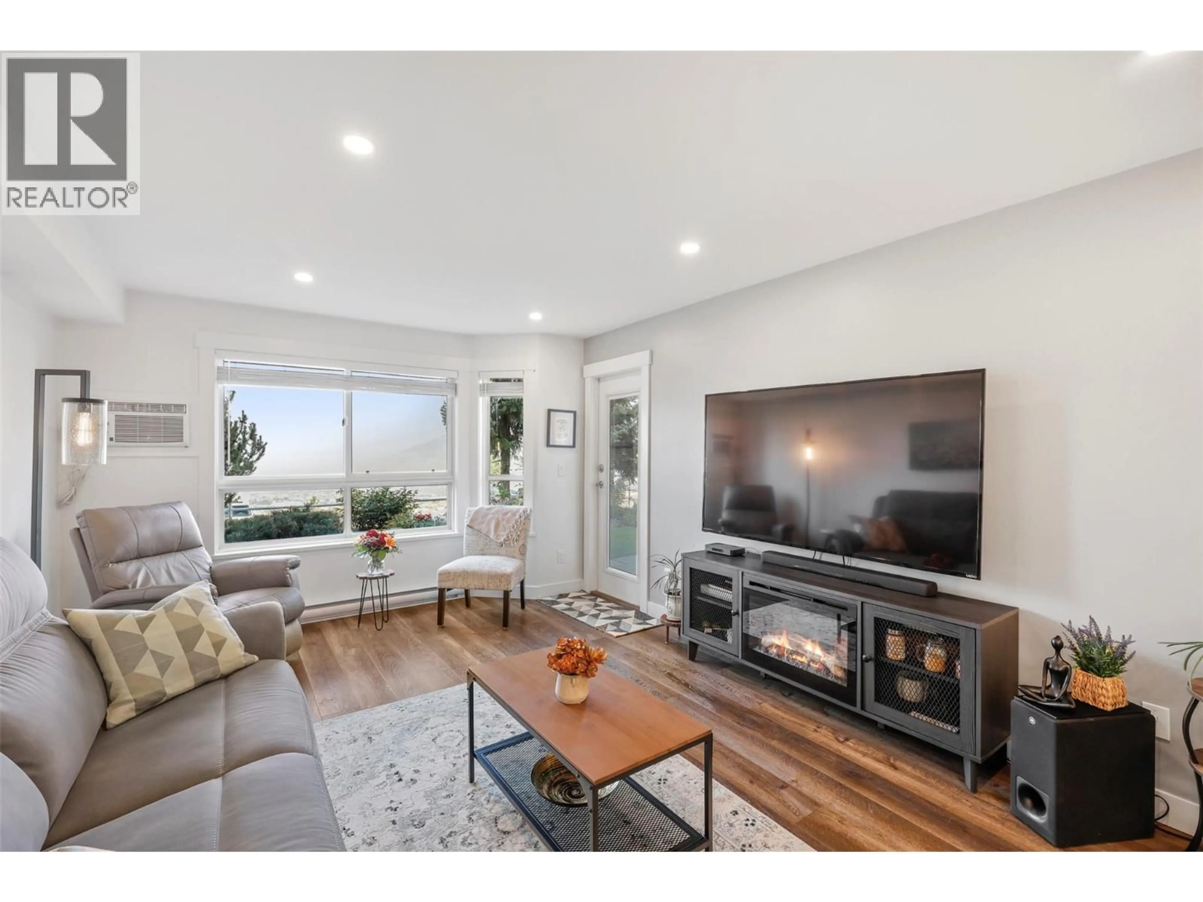 Living room with furniture, wood/laminate floor for 103 - 2025 PACIFIC WAY, Kamloops British Columbia V1S1V2