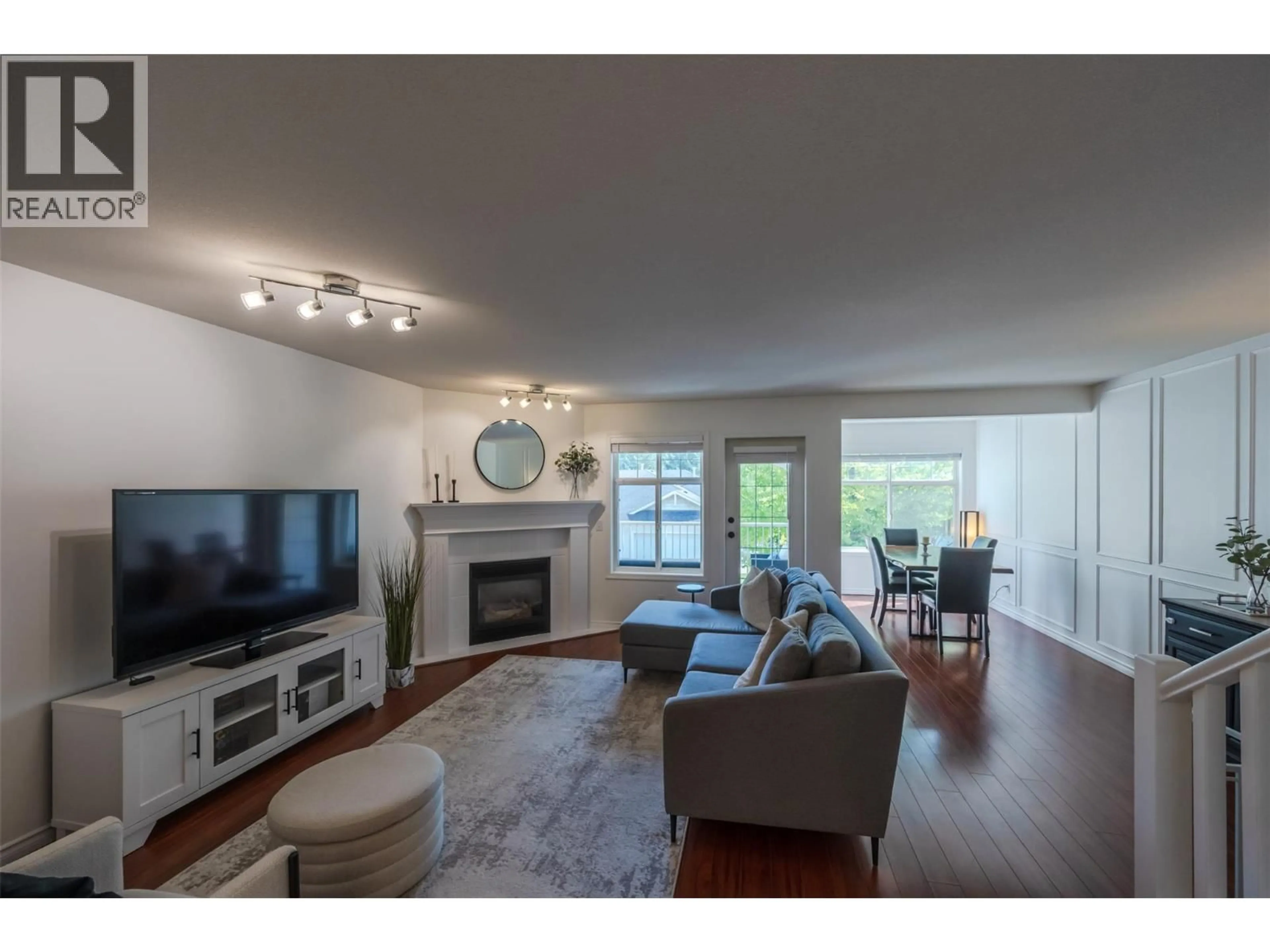 Living room with furniture, wood/laminate floor for 103 - 3825 GLEN CANYON DRIVE, West Kelowna British Columbia V4T2T4