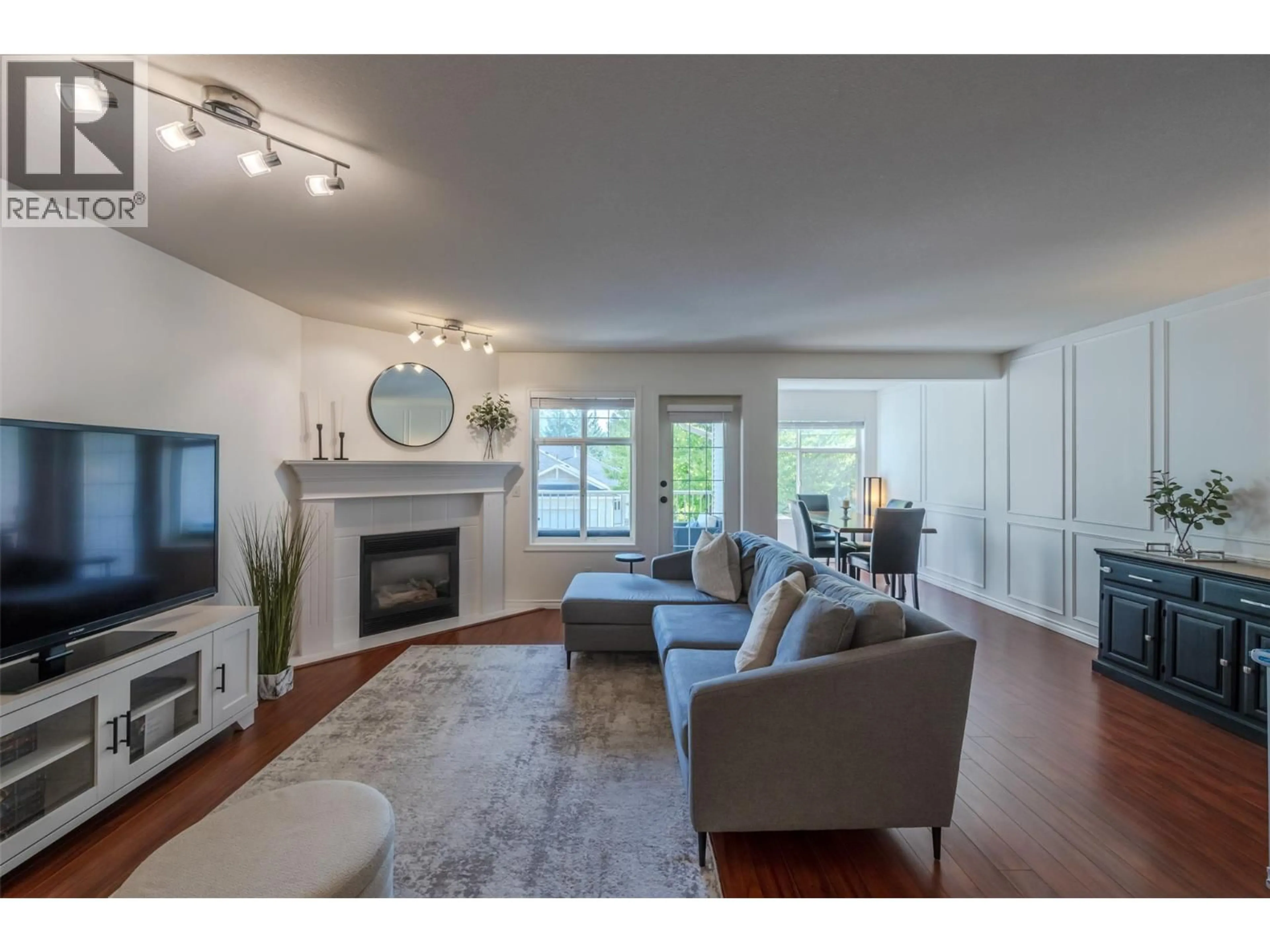 Living room with furniture, wood/laminate floor for 103 - 3825 GLEN CANYON DRIVE, West Kelowna British Columbia V4T2T4